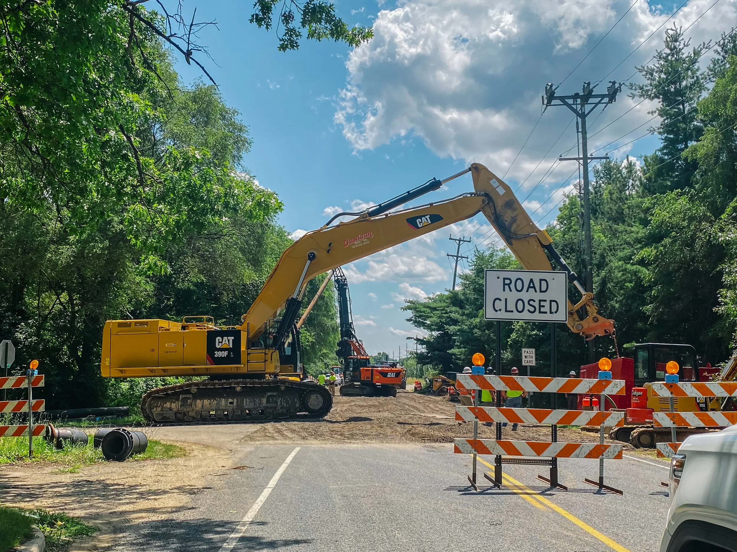 Dunigan Bros. excavator on an active road construction and underground utility project