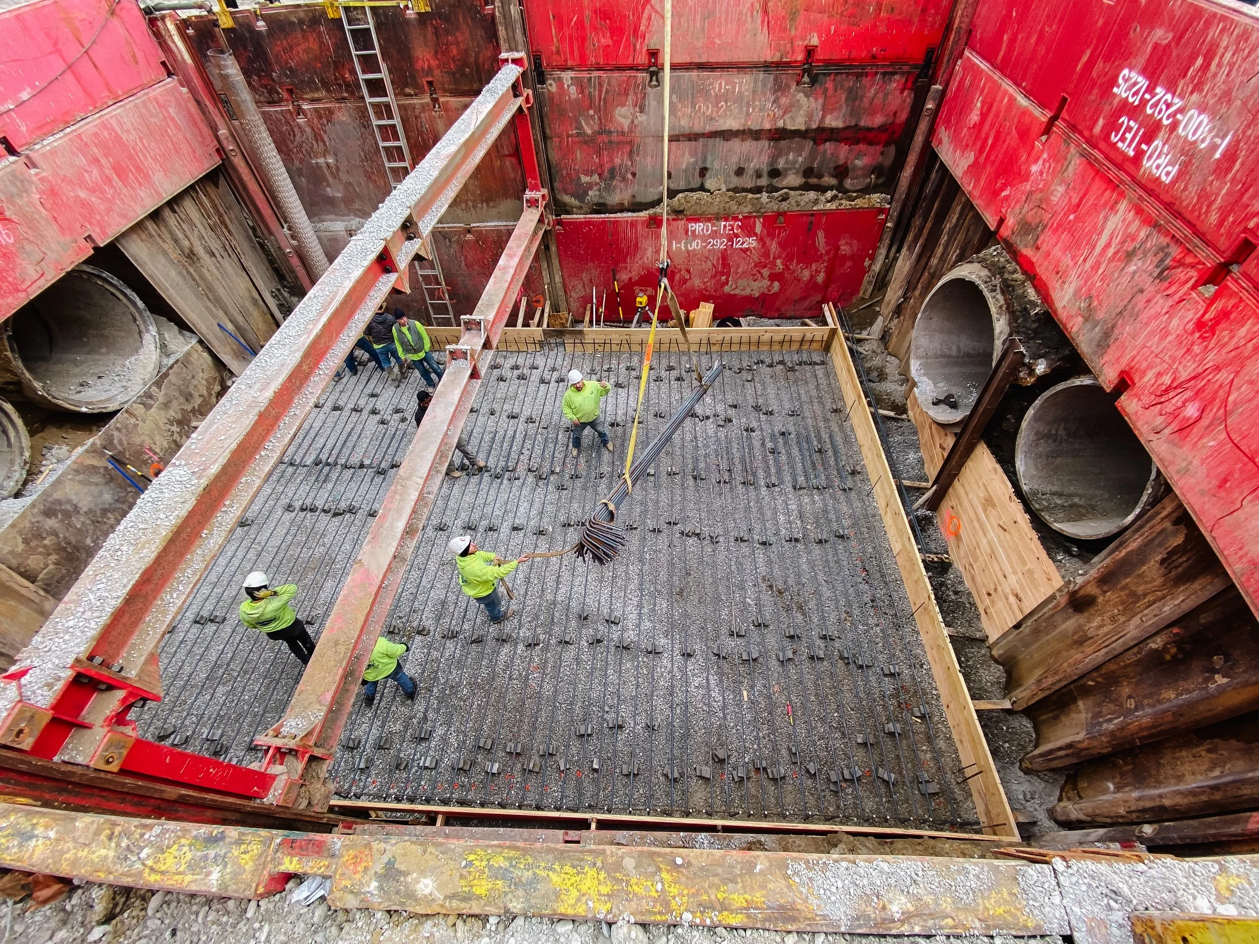 Dunigan Bros. crew members pouring structural concrete in a deep foundation excavation