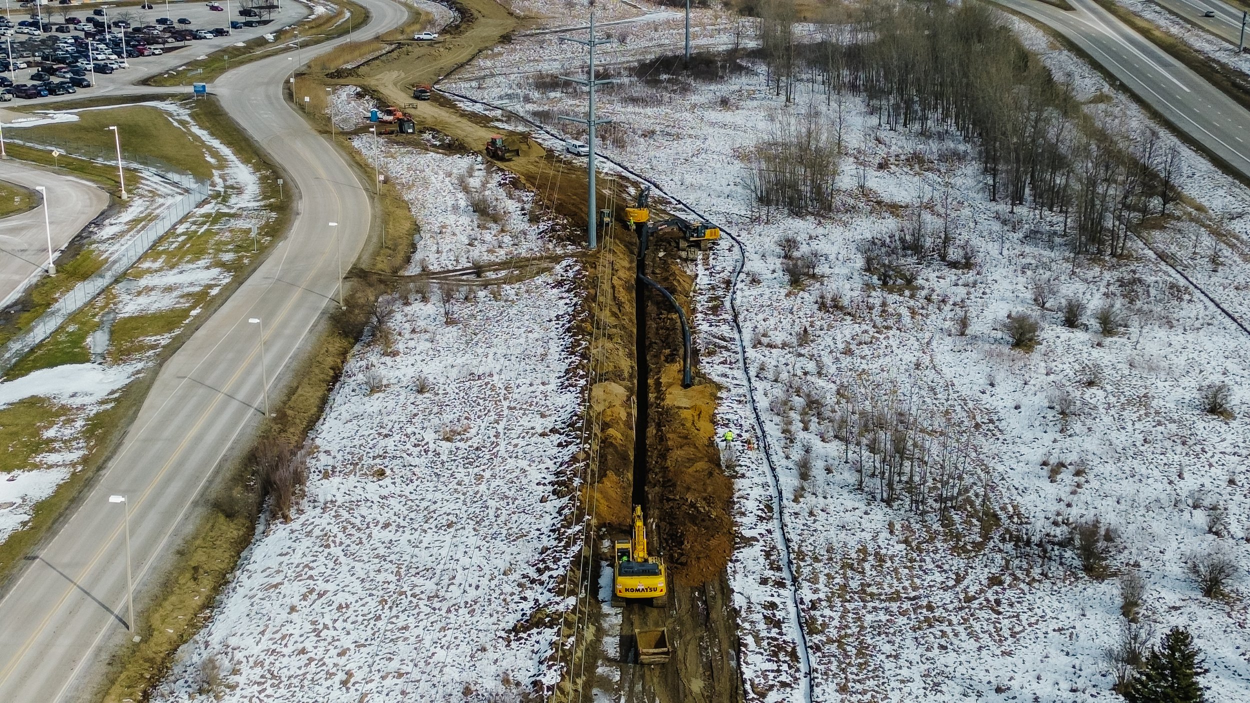 Dunigan Bros. aerial view of underground utility installation along a road corridor in winter conditions