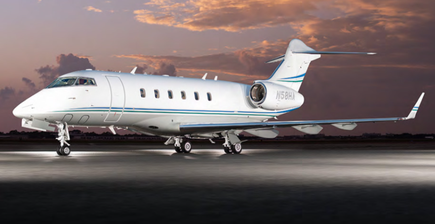 Private jet aircraft on the runway at sunset.