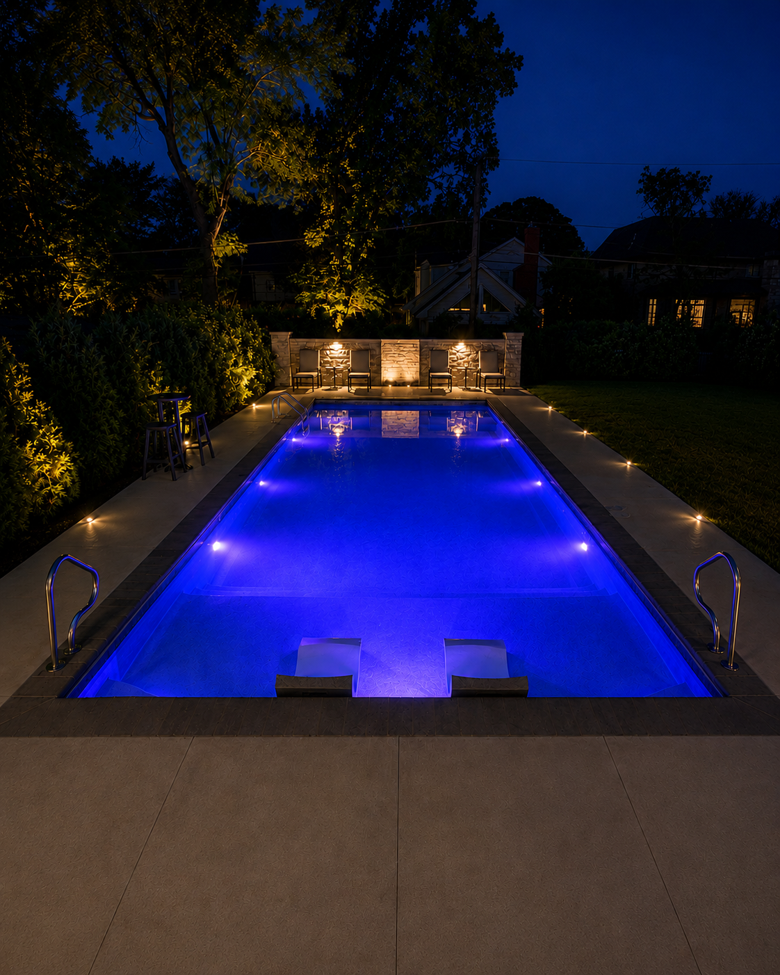 Landscape lighting and pool enhancements creating a dramatic nighttime outdoor environment in Downers Grove, Illinois.