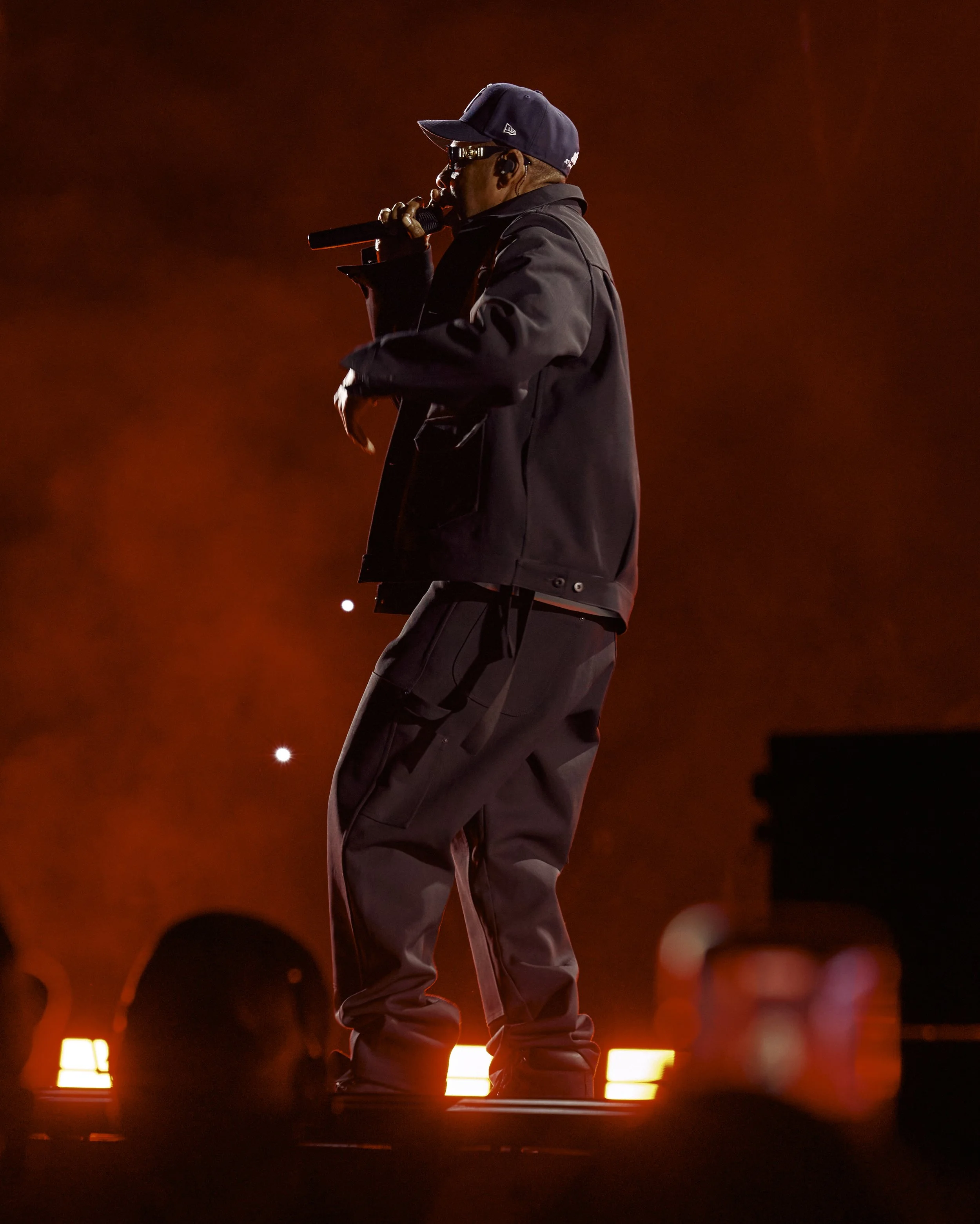 JAY-Z onstage at SoFi Stadium on October 24, 2026, performing under dramatic red lighting during his JAŸ-Z30 finale
