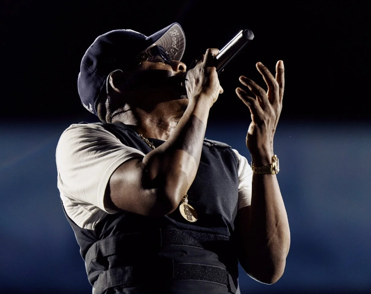 JAY-Z performing with a microphone and sunglasses during his October 23, 2026 JAŸ-Z30 concert at SoFi Stadium