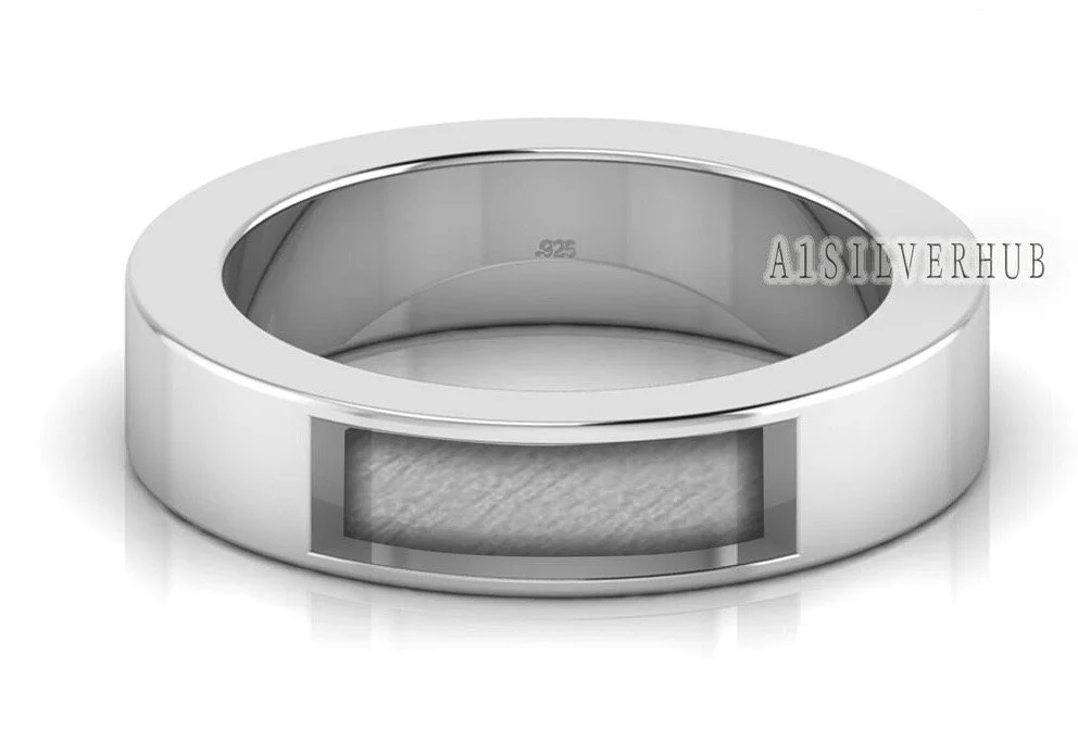 Close-up of a silver ring with a rectangular cutout ready for resin and ashes.