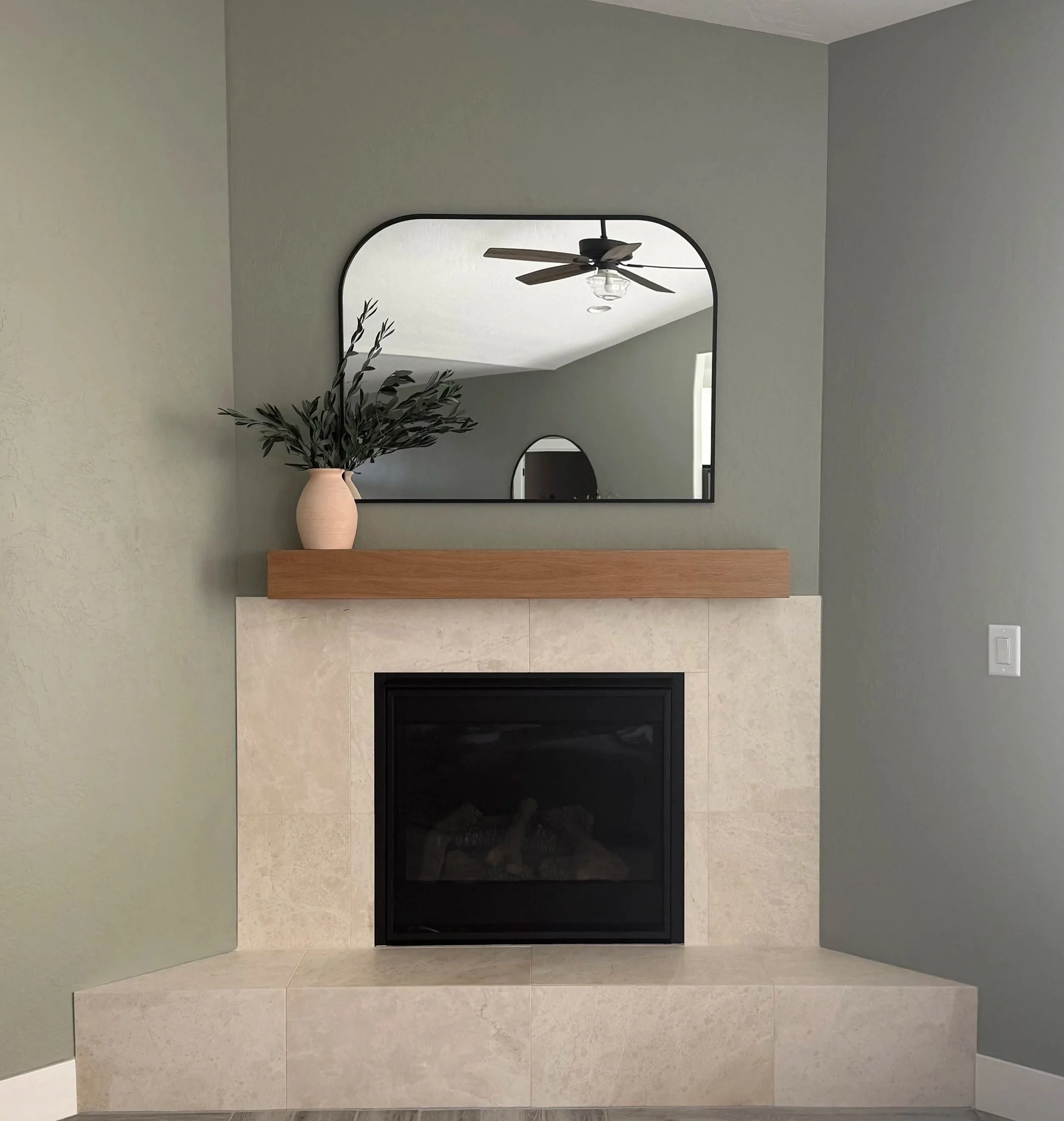 Natural stone fireplace remodel with custom white oak mantel by Solid Ground Tile Co. in Southern Oregon