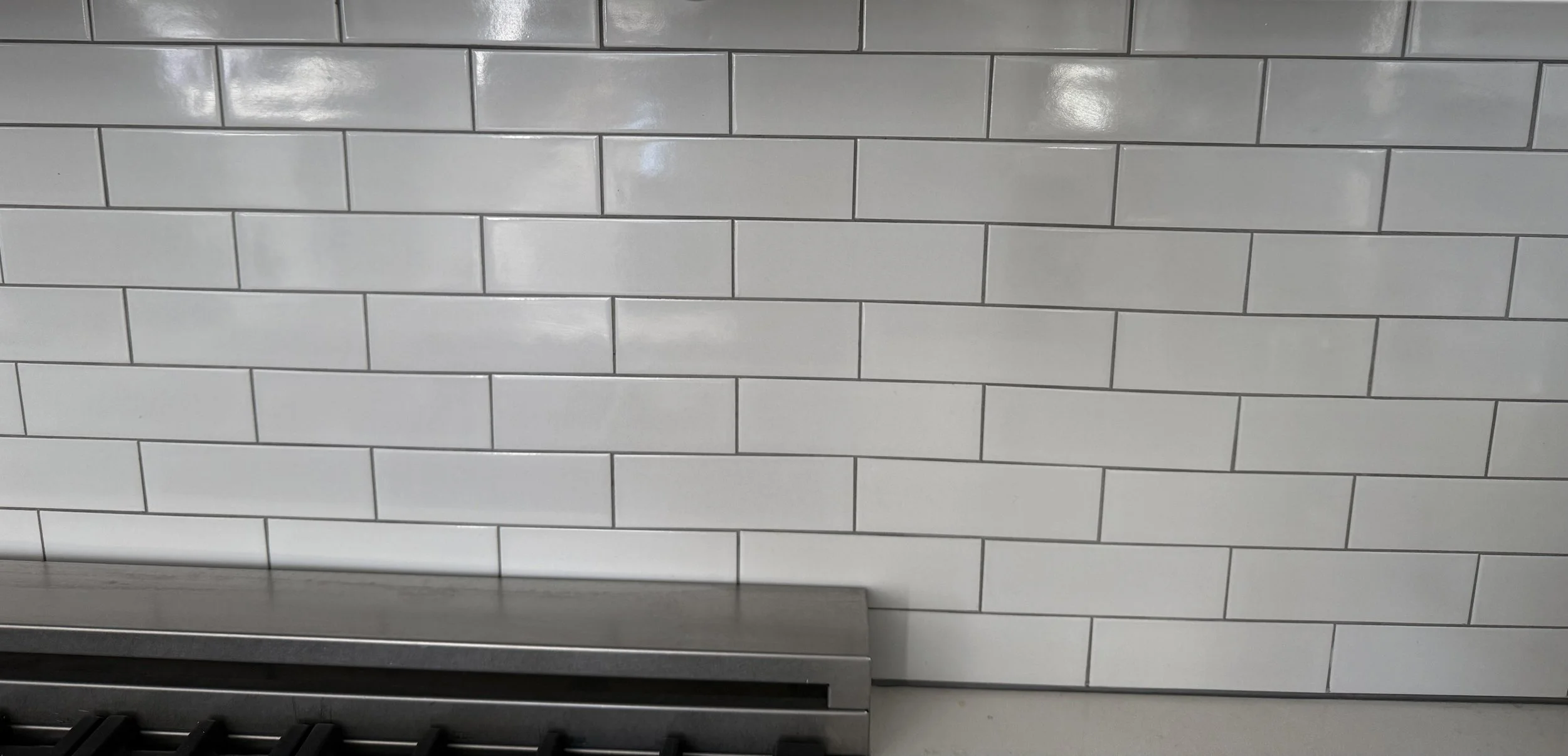 Custom kitchen backsplash with professionally installed tile, clean grout lines, and precise finishing details.