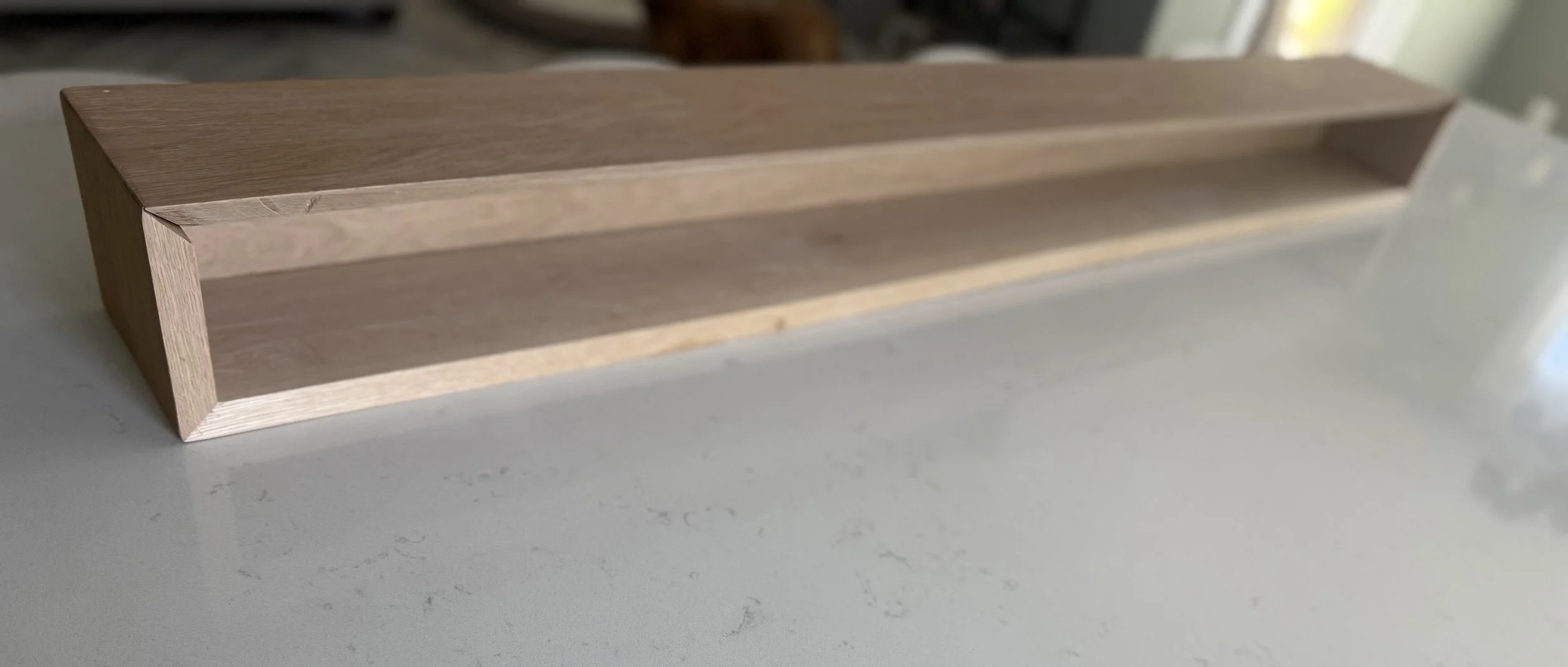 Underside detail of handcrafted white oak mantel showing clean wood construction