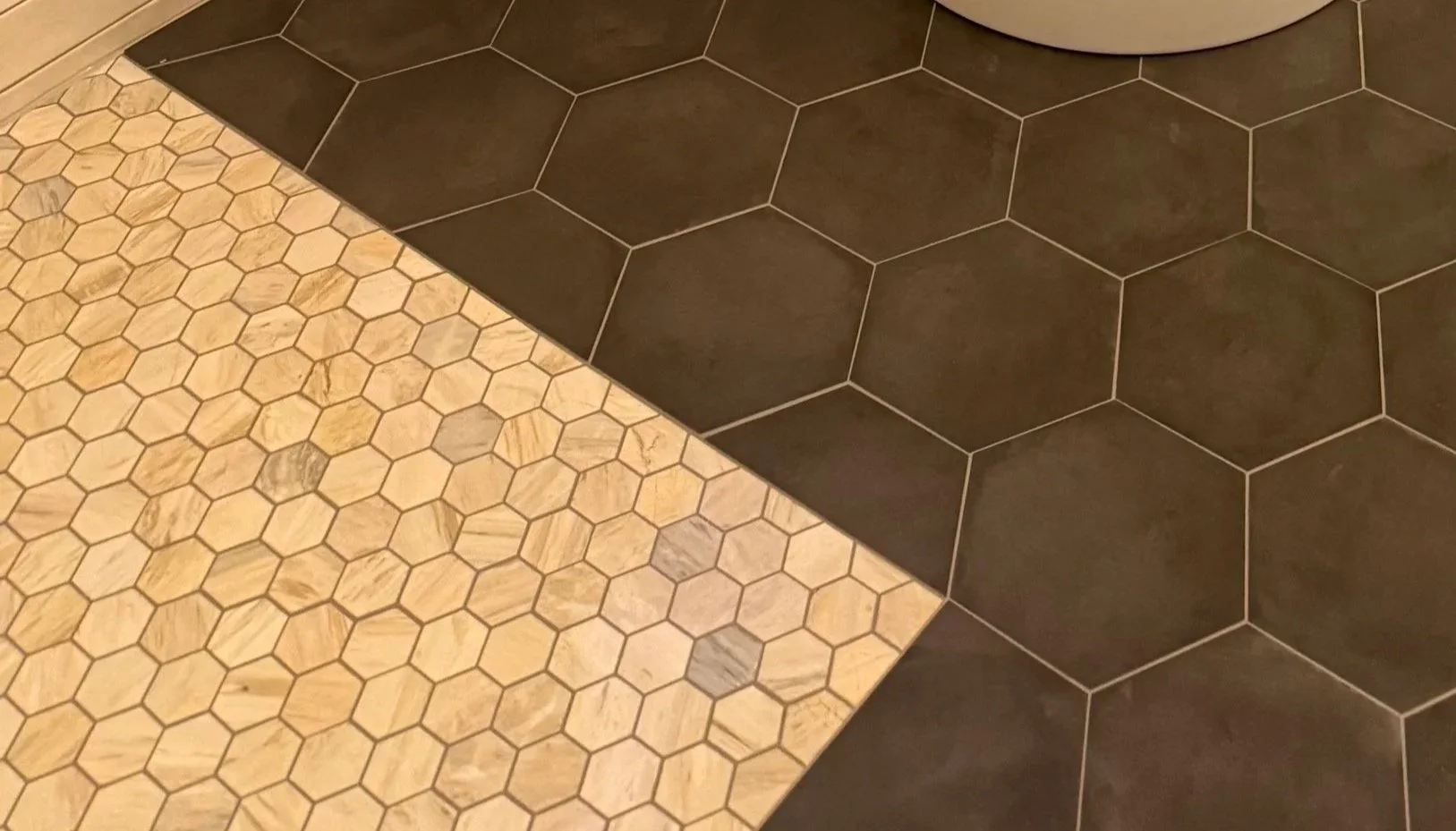 Clean tile floor transition demonstrating precise installation and professional finishing details.