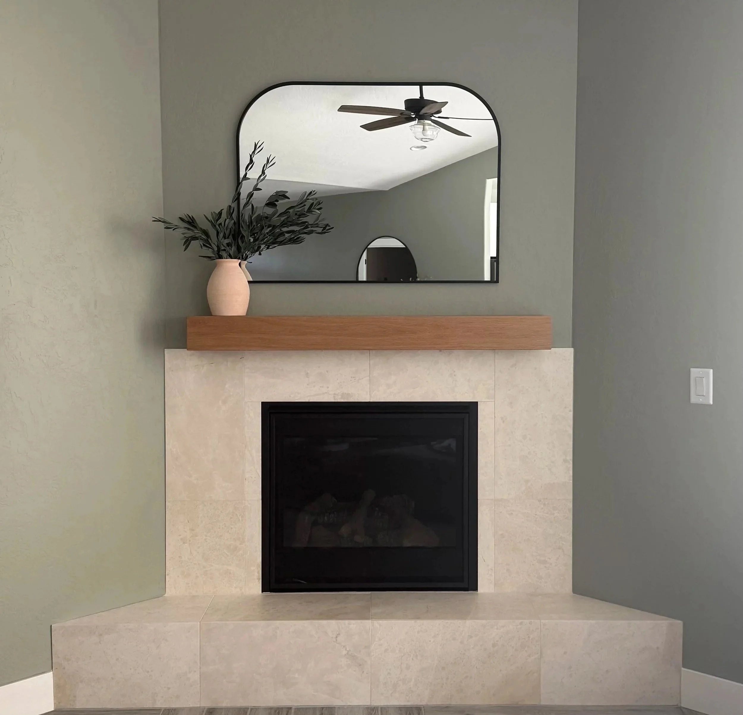 Modern tiled fireplace surround with custom white oak mantel by Solid Ground Tile Co. in Southern Oregon.