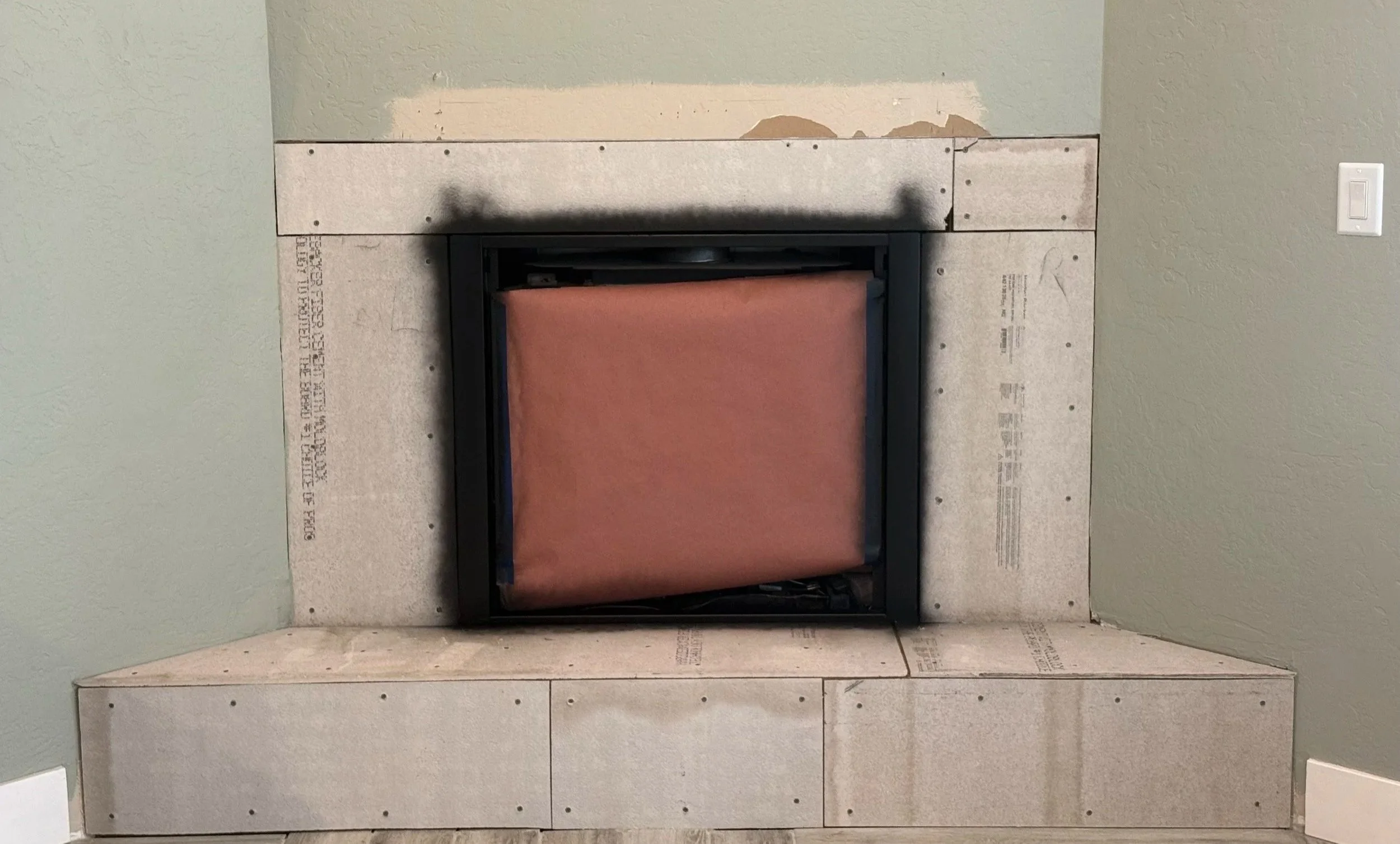 Fireplace surround prepared for large-format natural stone tile installation