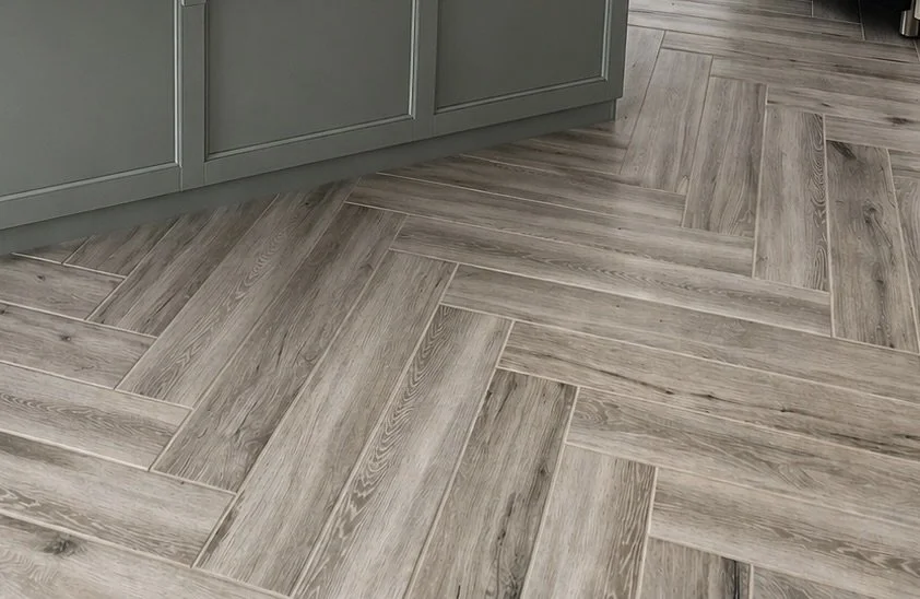 Custom herringbone tile floor installation showcasing precise layout and professional craftsmanship in a residential remodel.