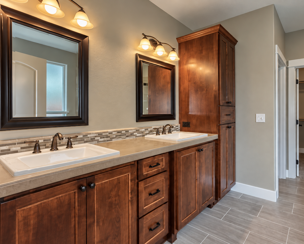 Primary bathroom vanity before remodel with dark wood cabinetry and beige tile flooring.