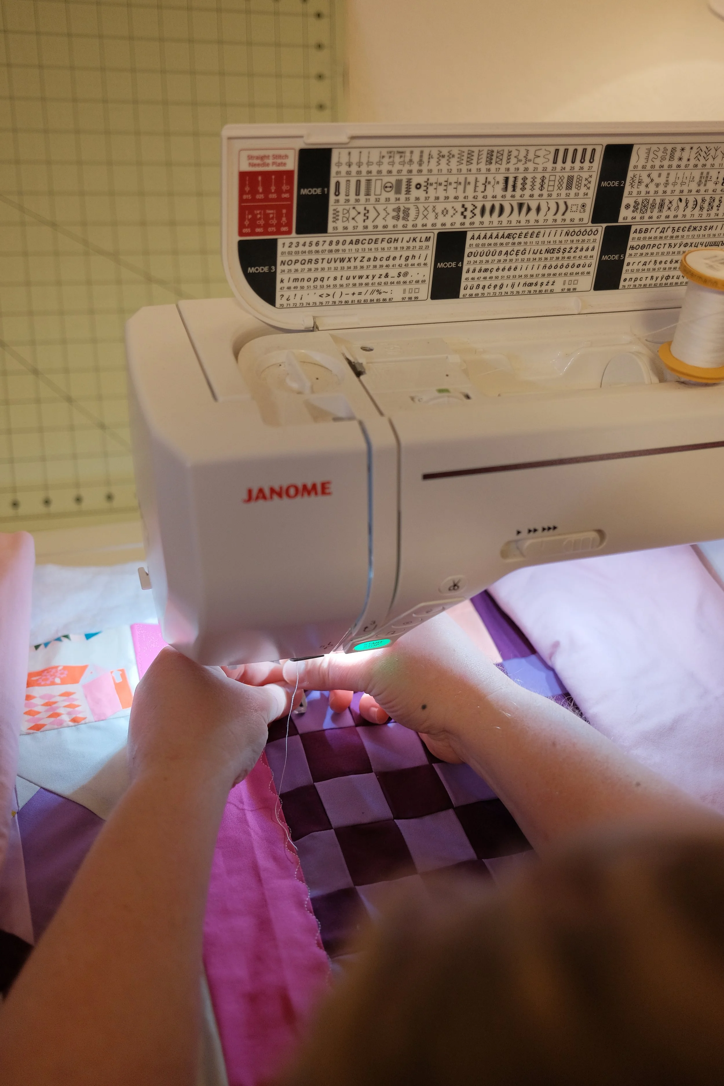 women threading sewing machine