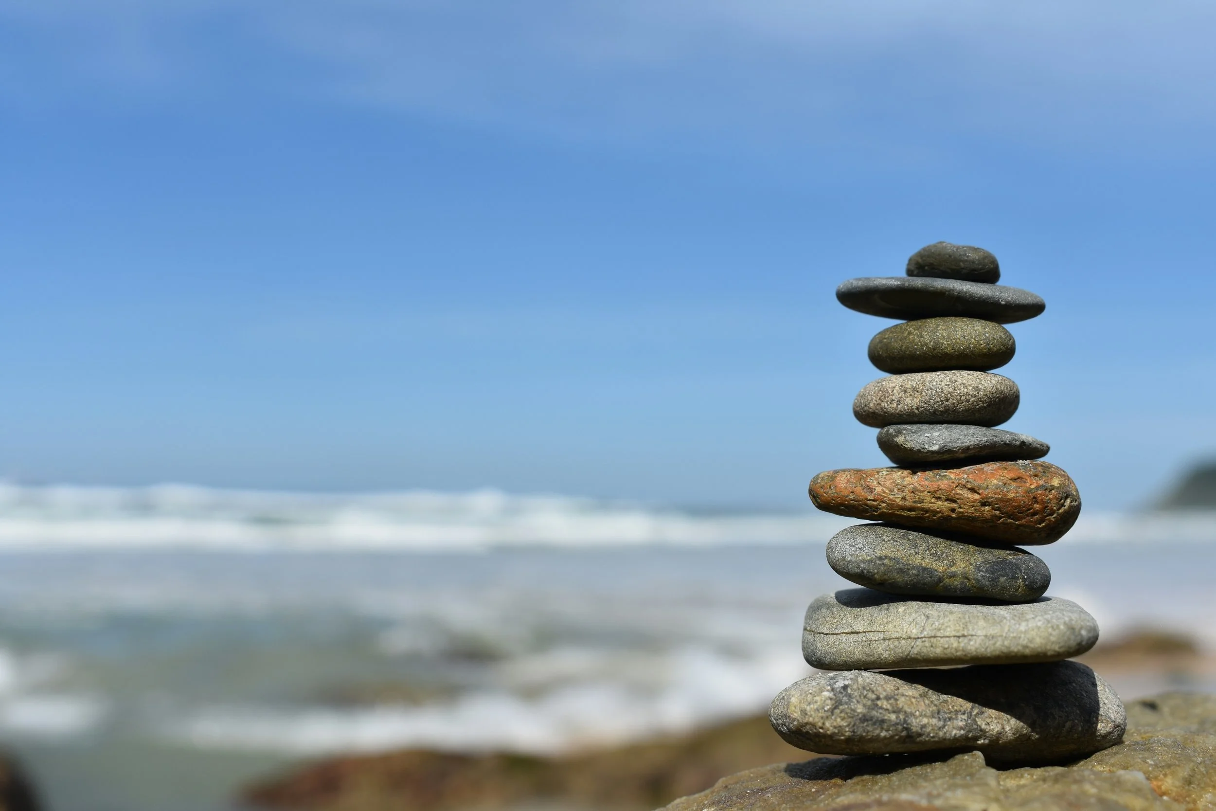 Stacked stones beside the ocean