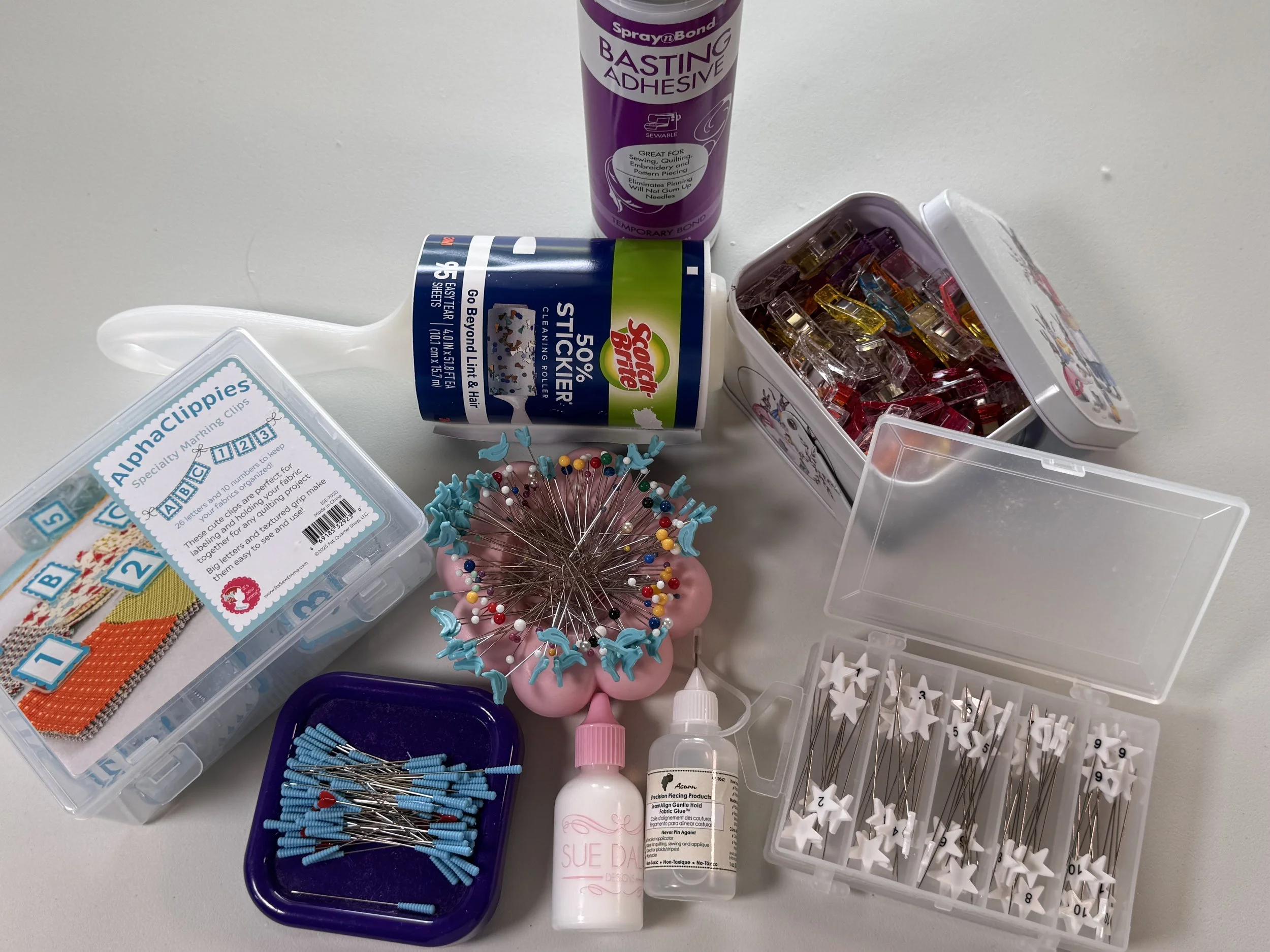 Sewing threads, hand-sewing supplies, and notions used for quilting and finishing.