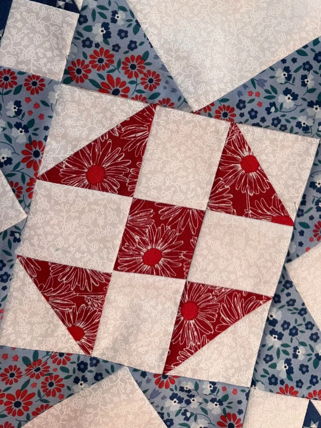 Four pink and blue patchwork quilt blocks arranged in a sampler. Explore quilting projects.
