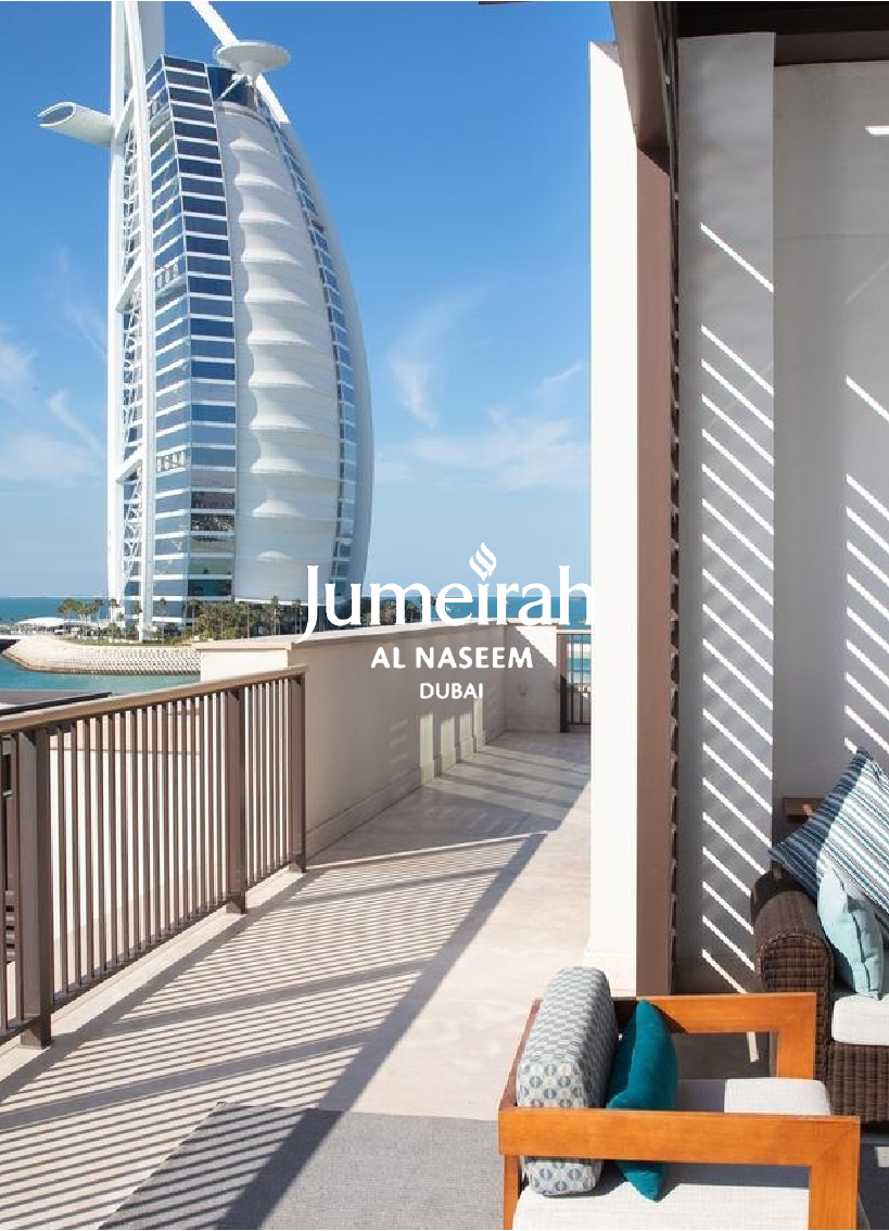 Balcony view of the Burj Al Arab hotel in Dubai with outdoor seating and sunny weather.