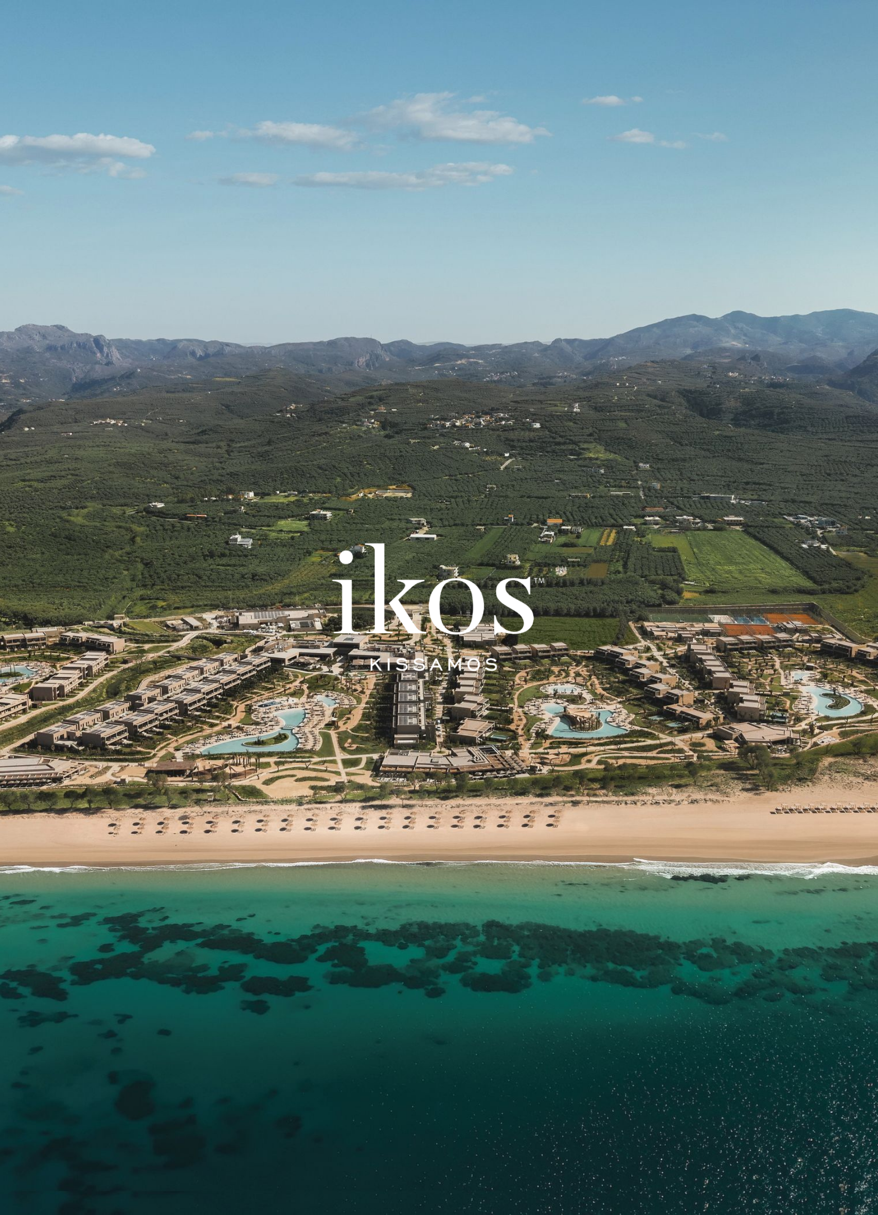 Bird's eye view of a resort with multiple swimming pools near the beach, surrounded by greenery and labeled 'Ikos Kissamos' in the foreground.