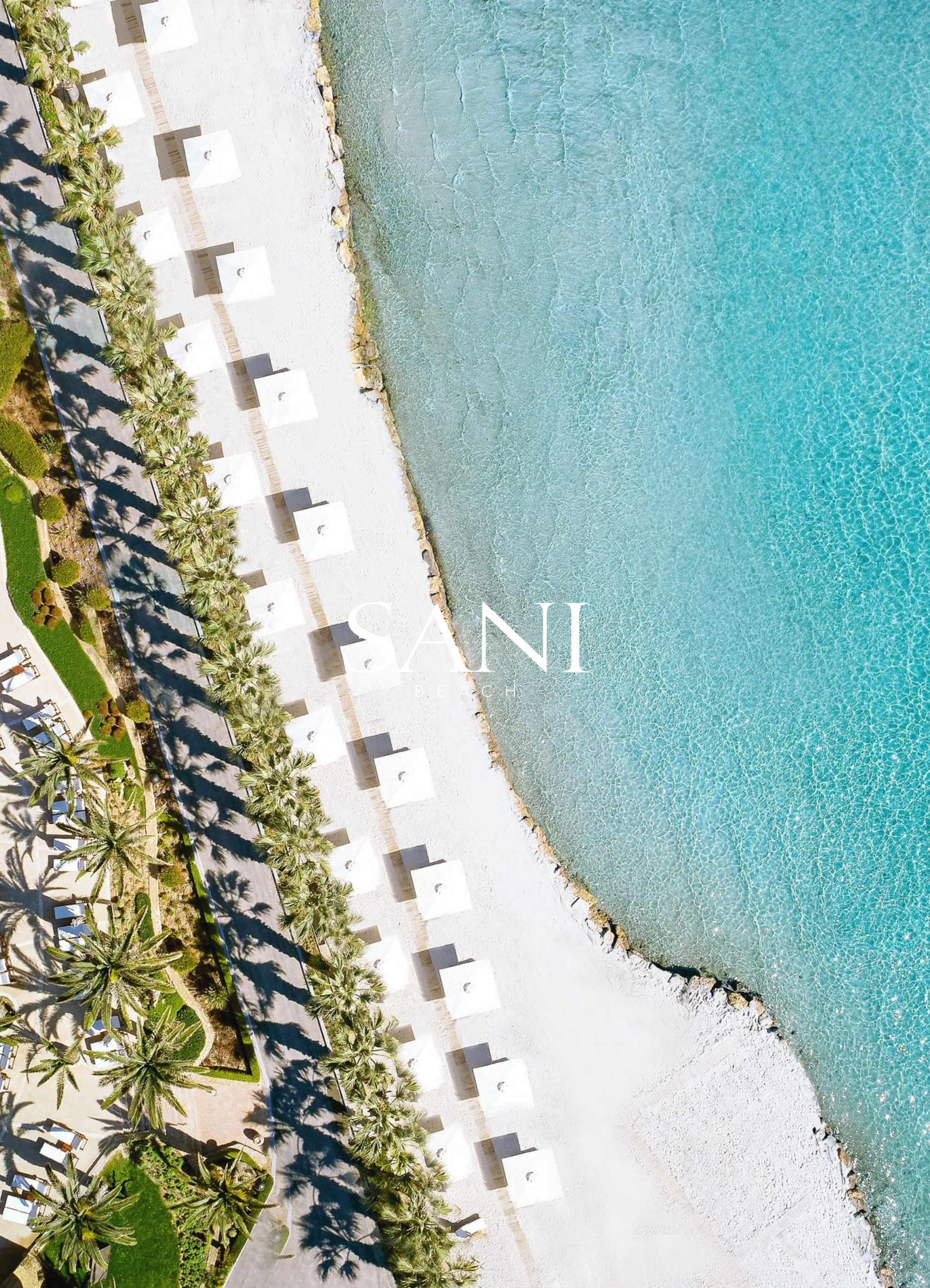 An aerial view of a beach with turquoise water, white sandy shore, and a row of tents with palm trees casting shadows on the ground.