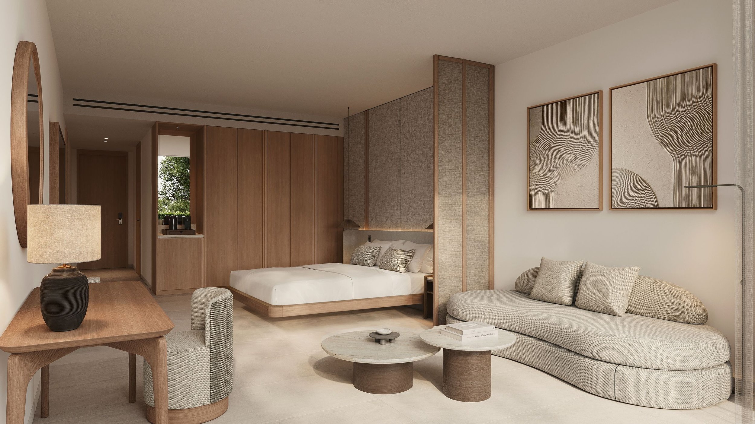 Modern hotel room with a white bed frame, beige sofa, wooden furniture, and abstract art on the wall.