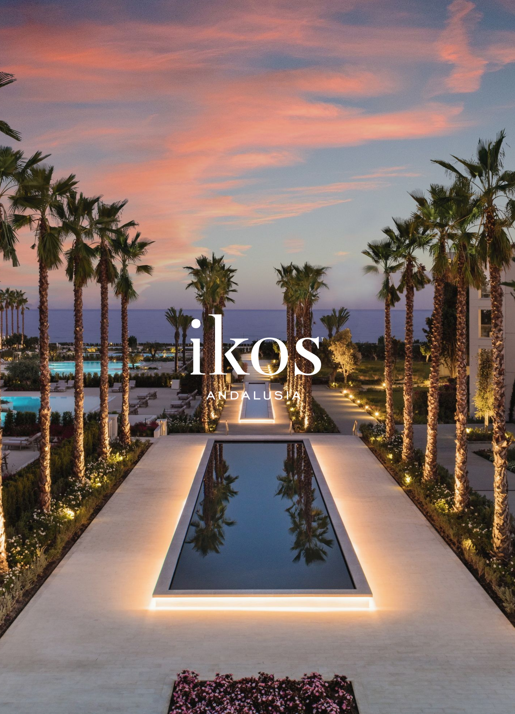 A luxurious outdoor pool area at sunset with tall palm trees lining a central water feature, modern landscaping, and a view of the ocean in the background.