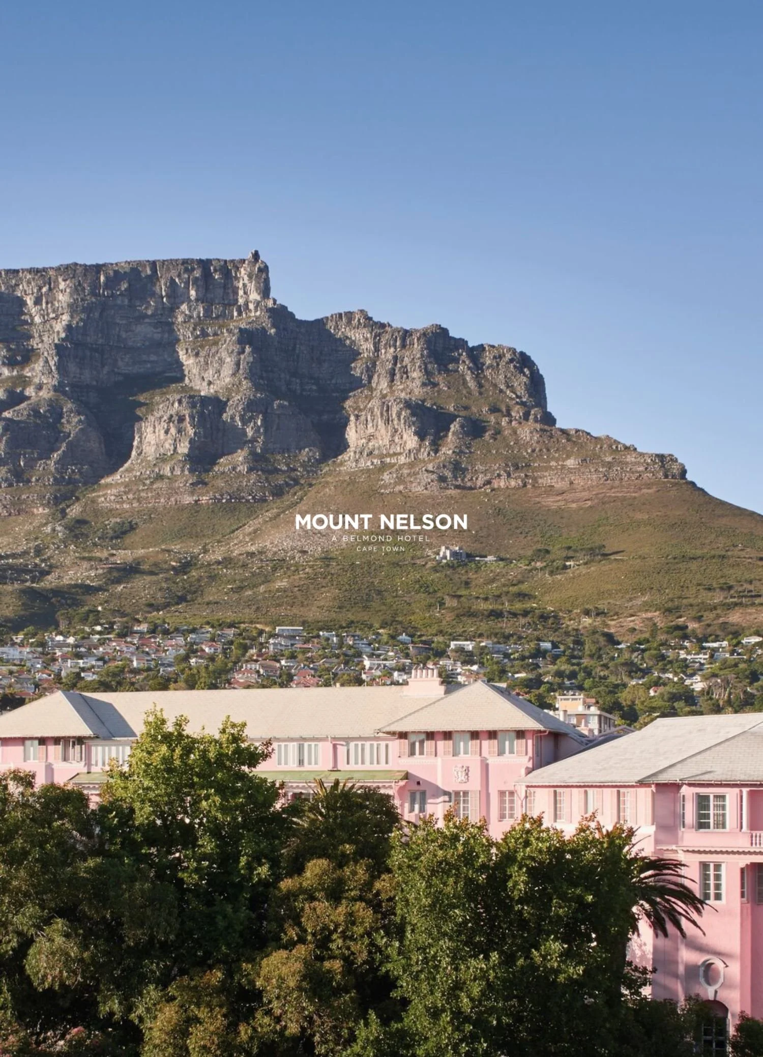 View of Table Mountain in Cape Town with a small building in the foreground and a clear blue sky.