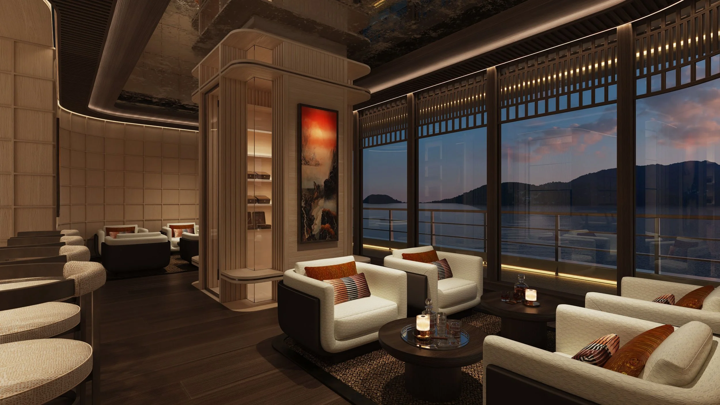 A luxurious lounge area with white armchairs and sofas, dark wooden tables, large windows with a view of water and mountains at sunset, and modern decor including a large painting and warm lighting.
