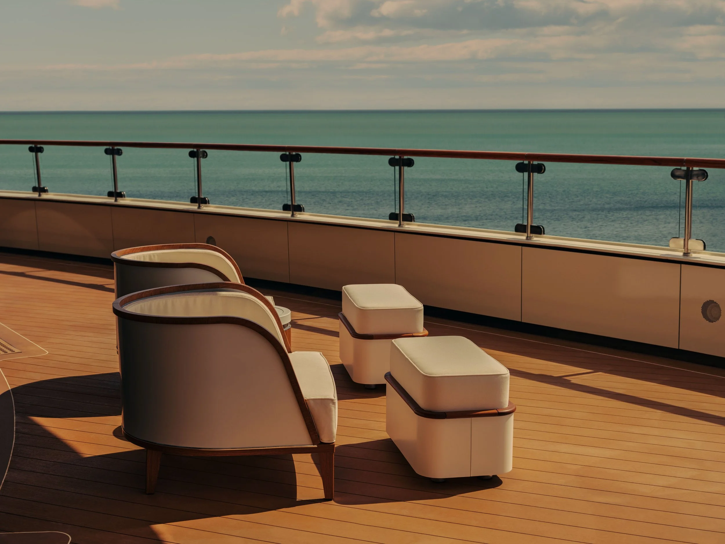 View of an outdoor deck area overlooking the ocean with beige chairs, cushions, and a railing.