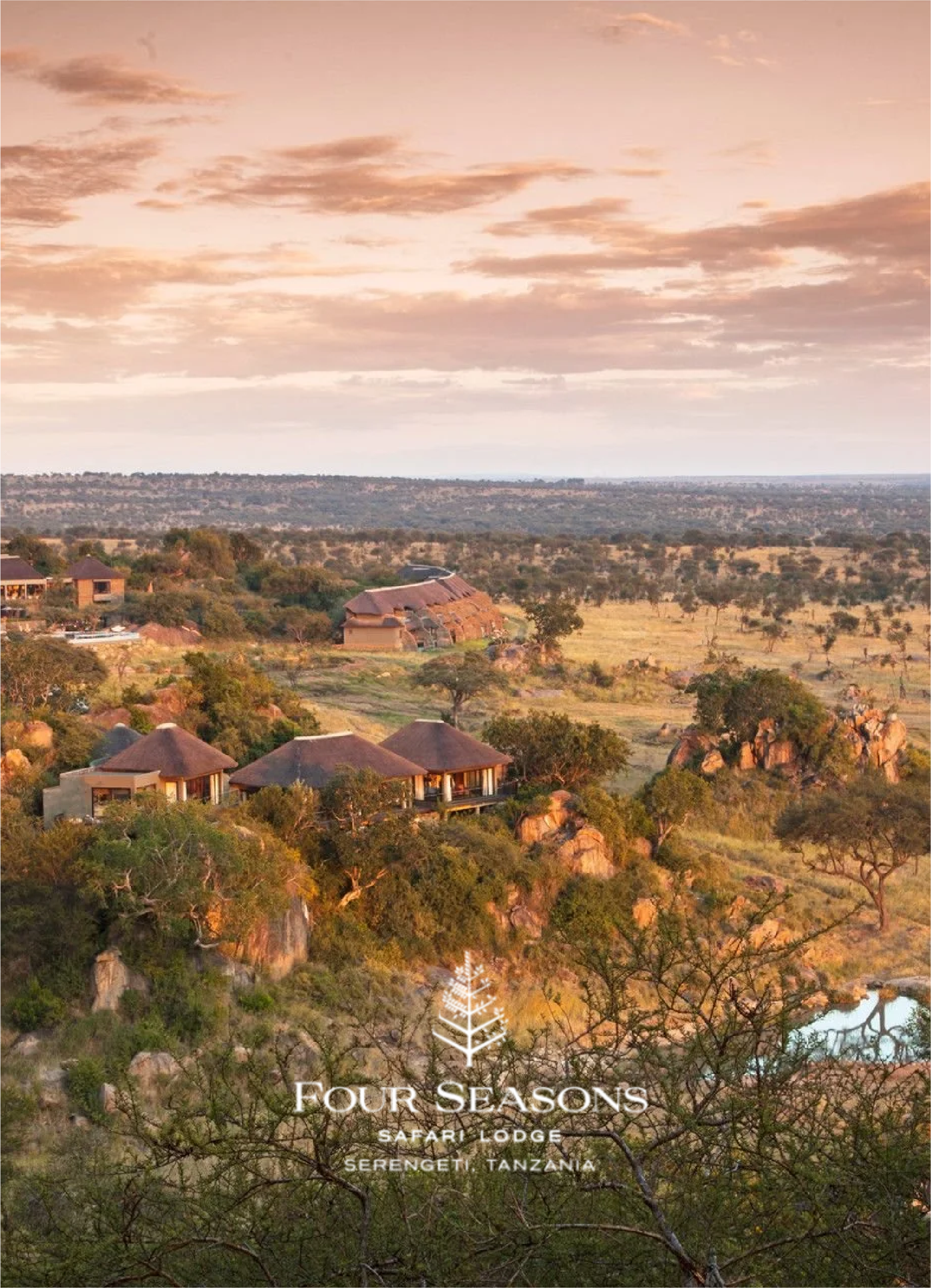 A scenic view of the landscape at dawn with rooftops of huts, surrounded by trees, rocky formations, and a vast horizon sky with clouds. Text overlay reads "Four Seasons Safari Lodge Serengeti, Tanzania."