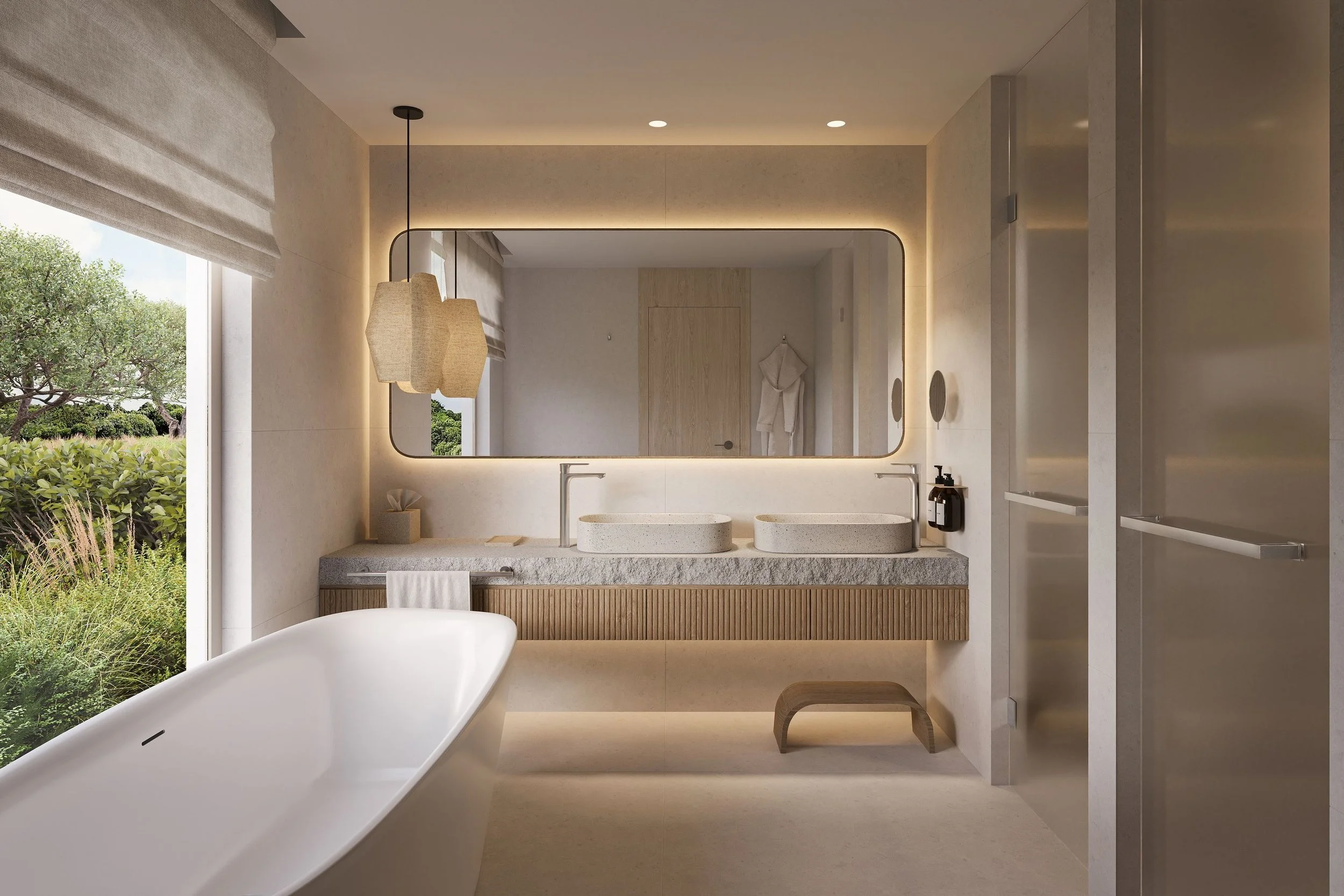 Modern bathroom with a freestanding bathtub, a large backlit mirror, a double sink vanity with stone countertops, and a window showing lush greenery outside.