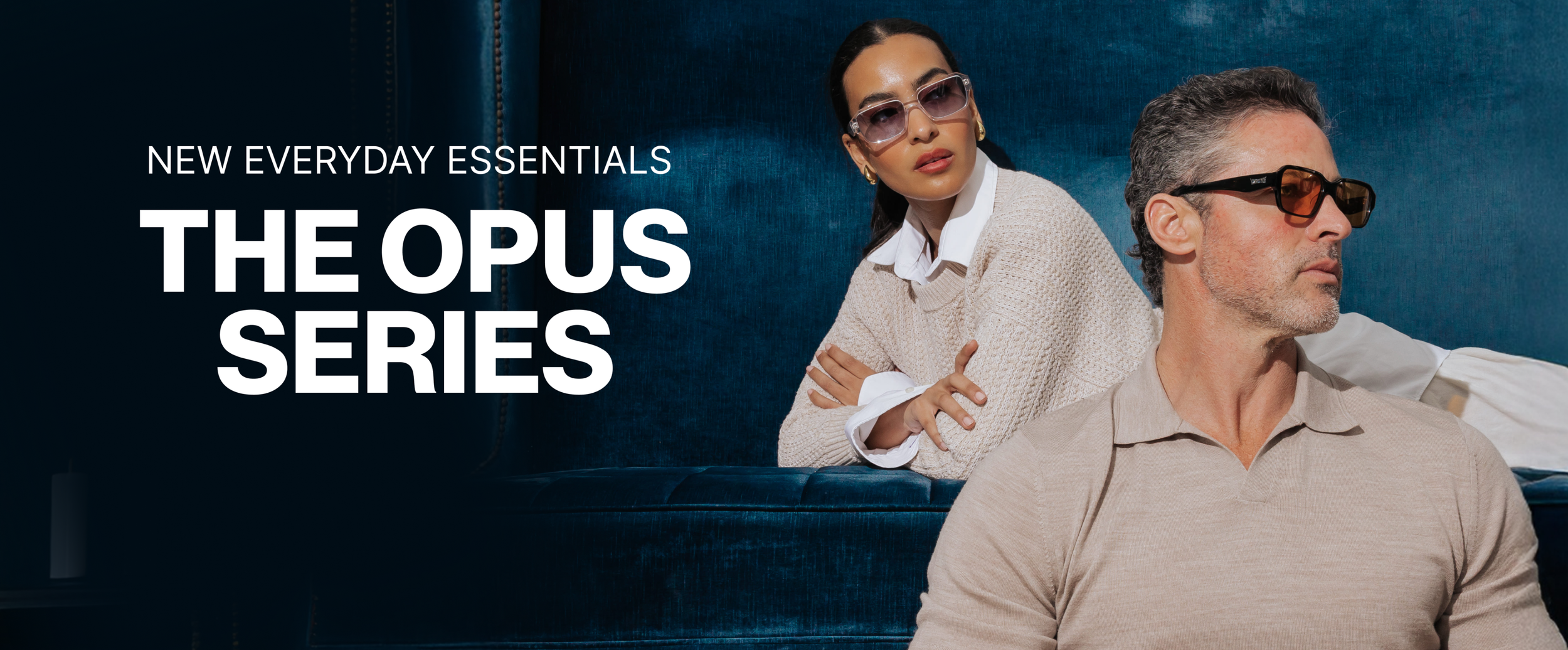 Two models, a woman and a man, wearing sunglasses, sitting on a blue couch with a dark background, promoting the Opus Series of sunglasses.