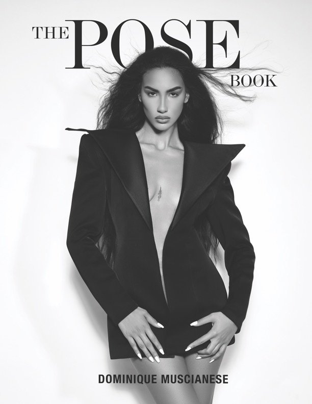 Cover of the book titled "The Pose Book" by Dominique Muscianese featuring a woman with long hair, wearing a black blazer, standing against a white background.
