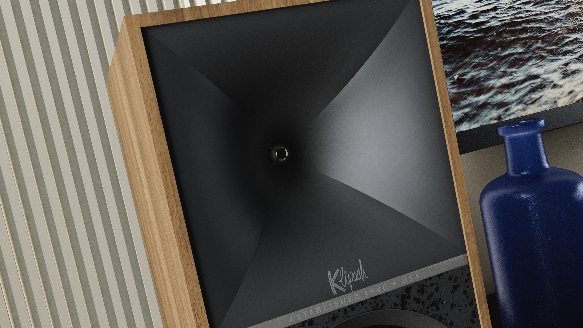 A Kenmore black trash can with a wooden frame and a visible brand signature, placed on a speckled surface near a blue ceramic bottle and a television displaying a water scene.