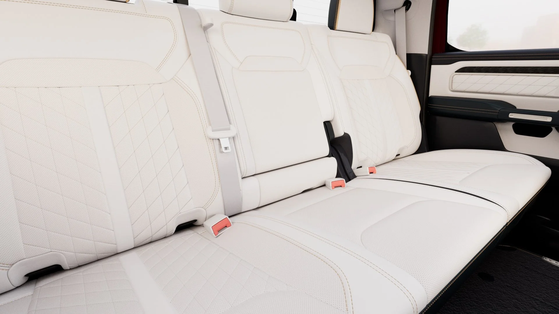 Interior of a vehicle showing white leather seats with diamond stitching and seatbelts.