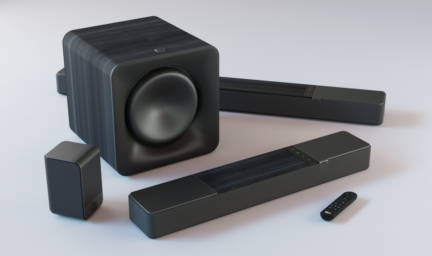 A home theater sound system with a large black subwoofer and three black rectangular soundbars, along with a remote control, arranged on a light-colored surface.