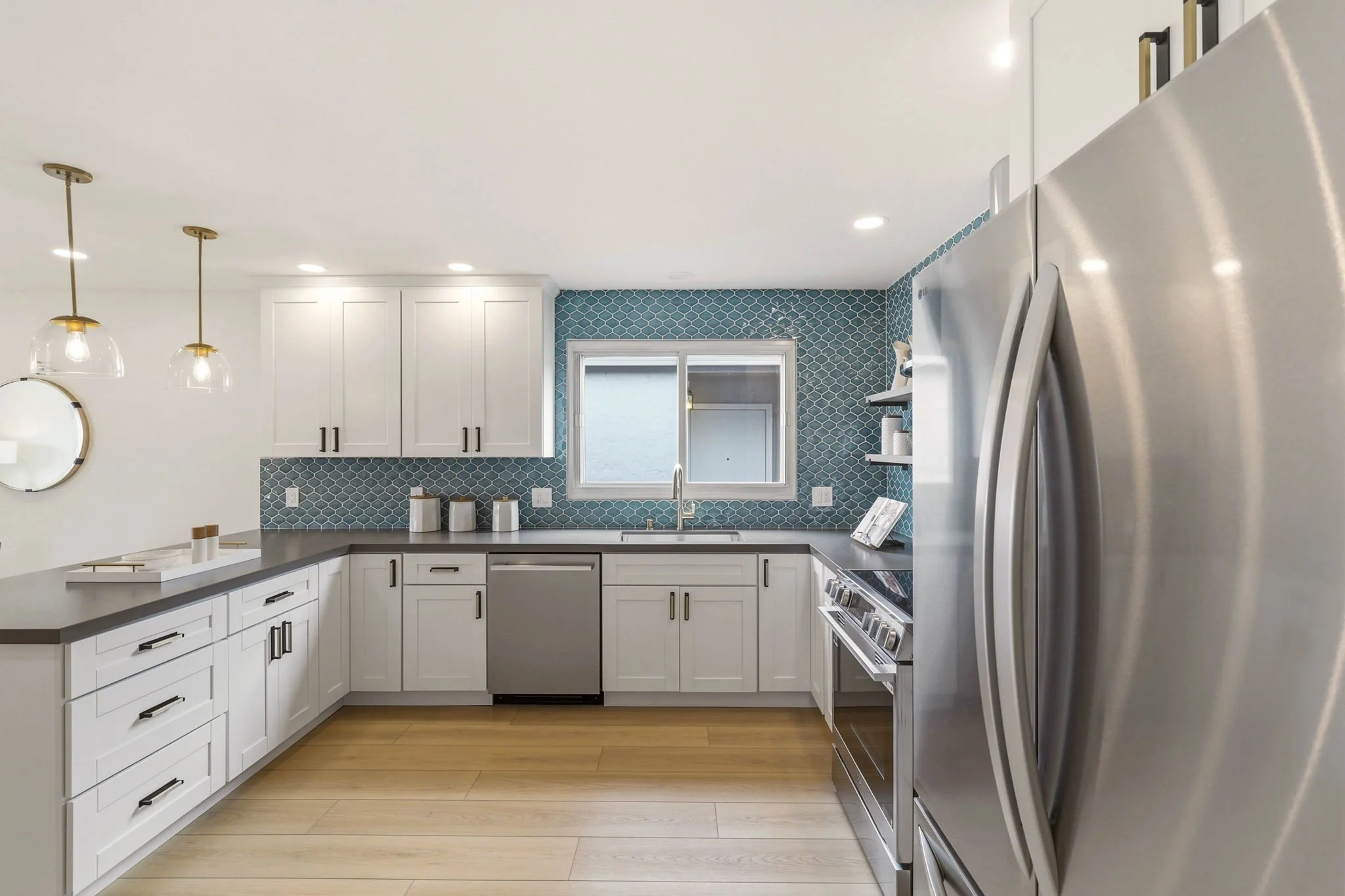 Remodeled kitchen with blue tile backsplash