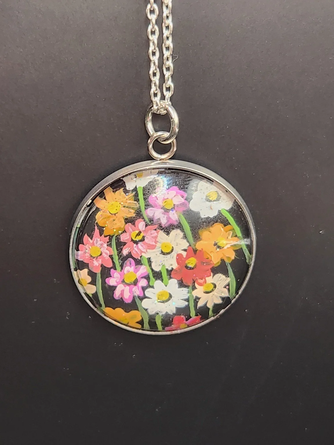Colorful cosmos flower art pendant hanging from a silver-tone chain. Chain not included.