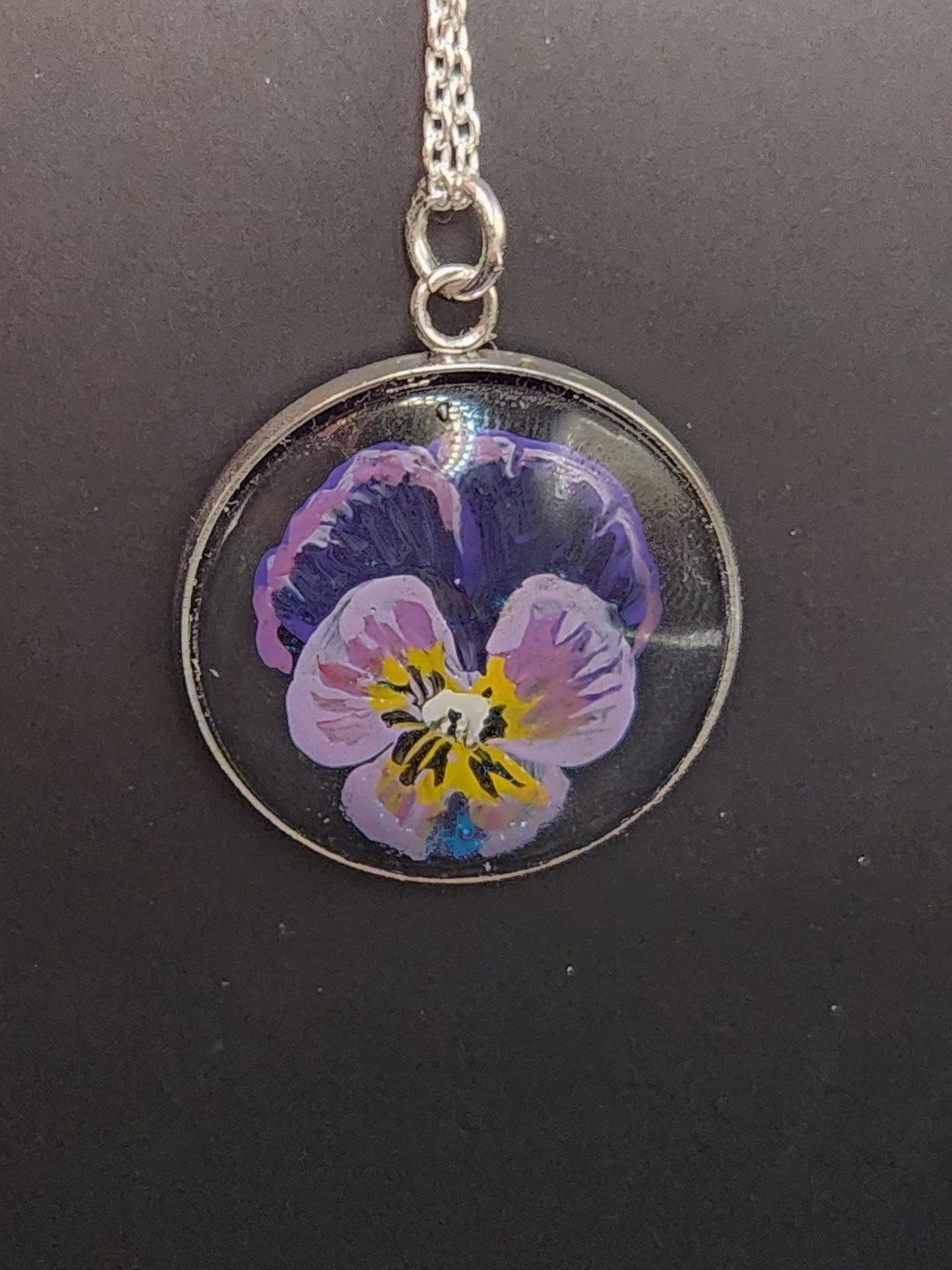 Viola pendant shown on a chain for styling; chain not included.