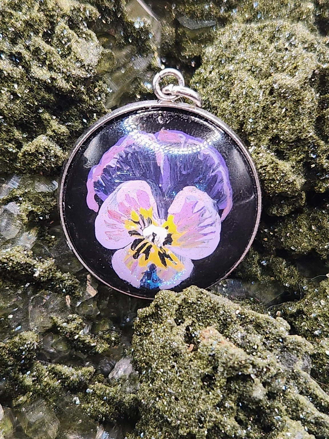 Viola flower pendant on a crystal display; display not included.