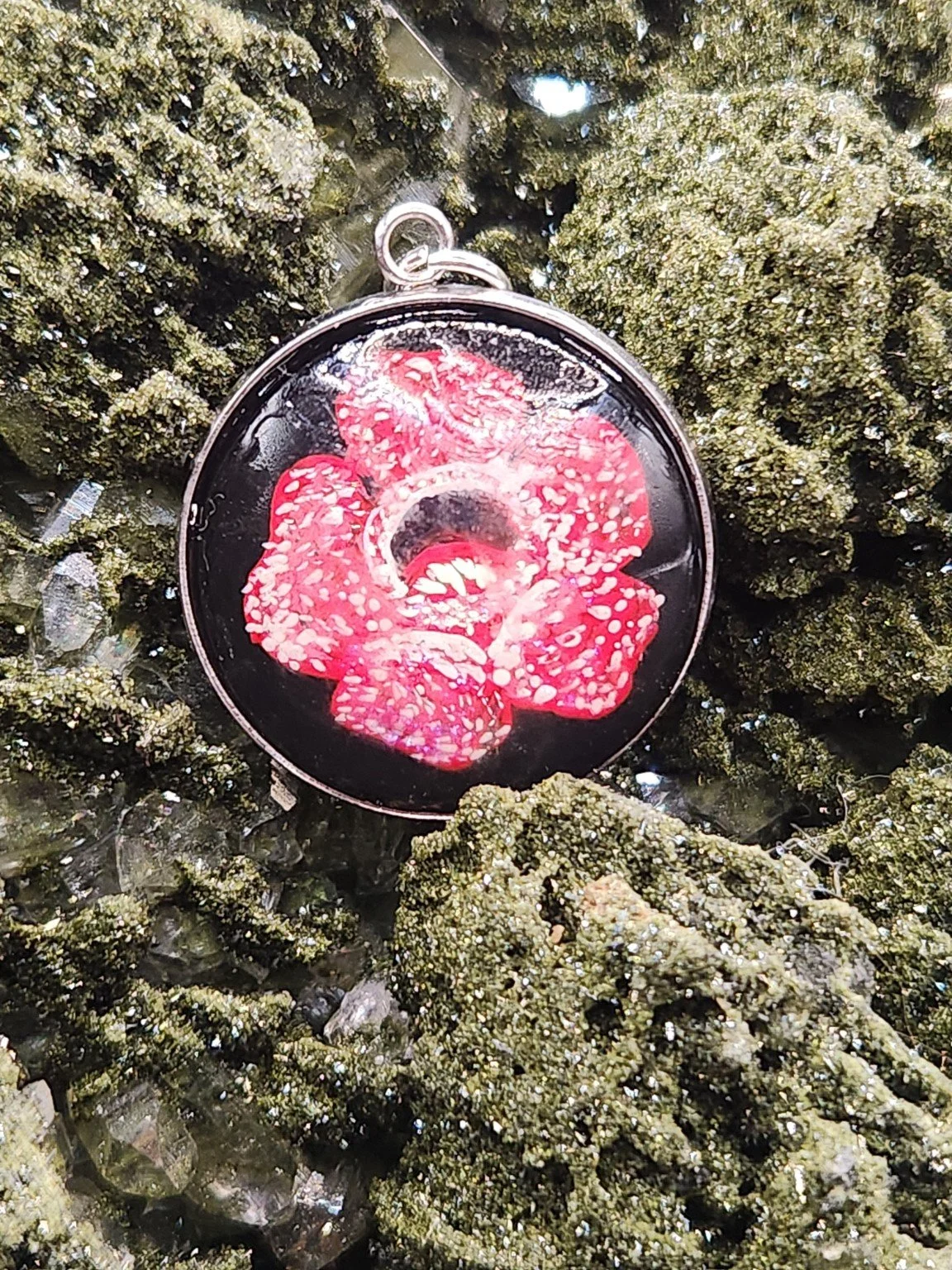 Rafflesia pendant on a crystal display; display not included.