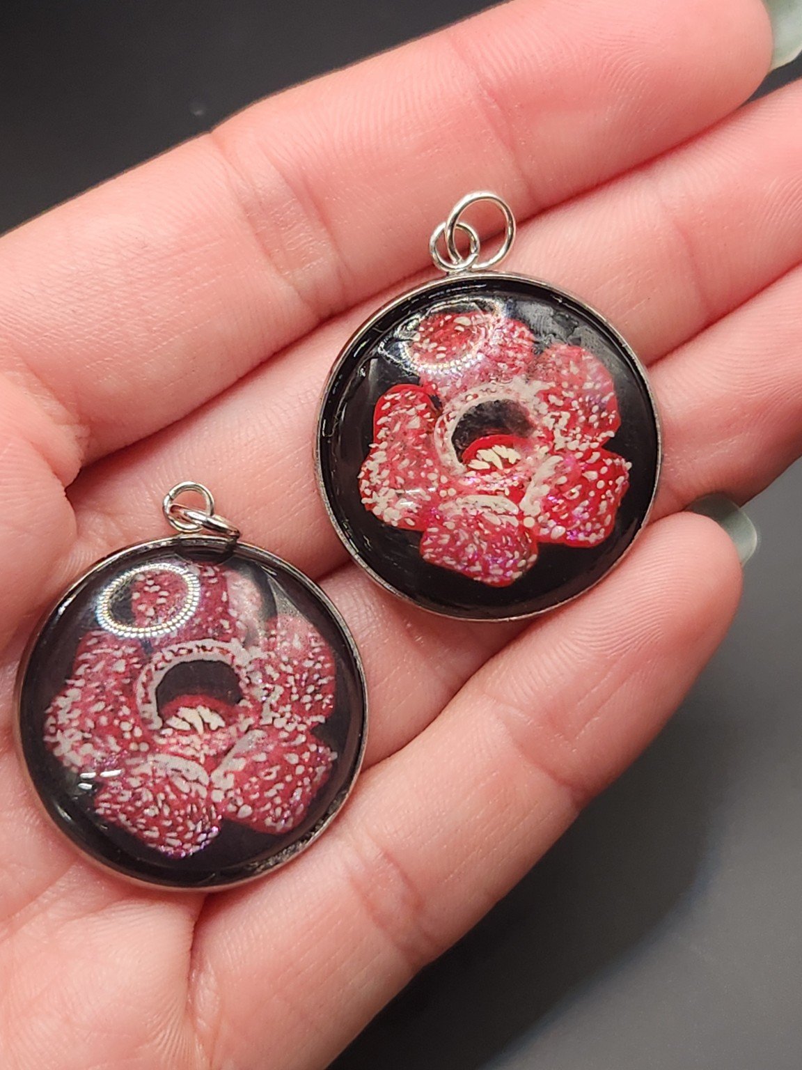 Rafflesia pendant comparison: hand-painted original at the top right and printed reproduction at the bottom left.