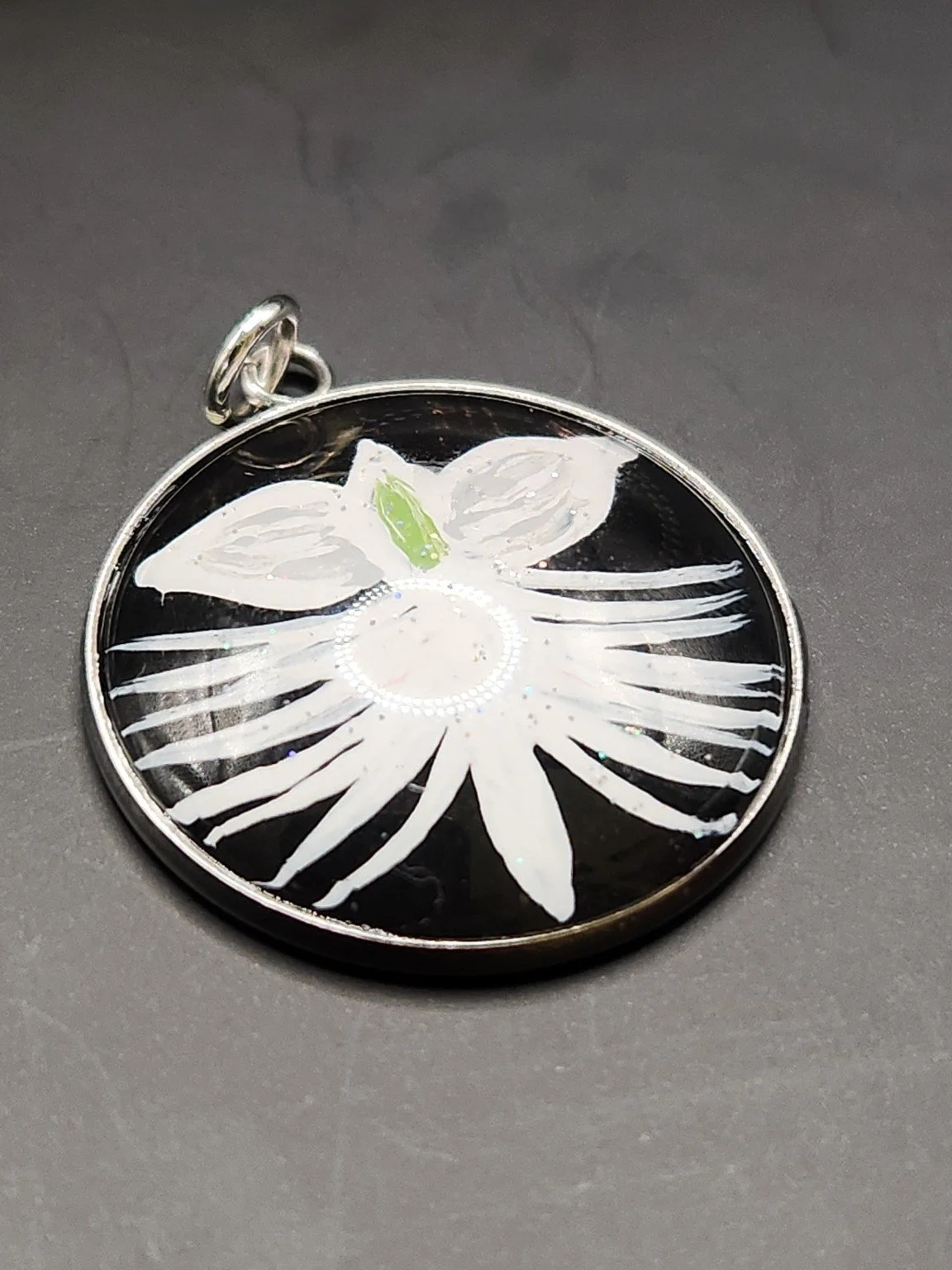 White dove orchid flower art pendant with sparkling glitter accents in a silver-tone bezel.