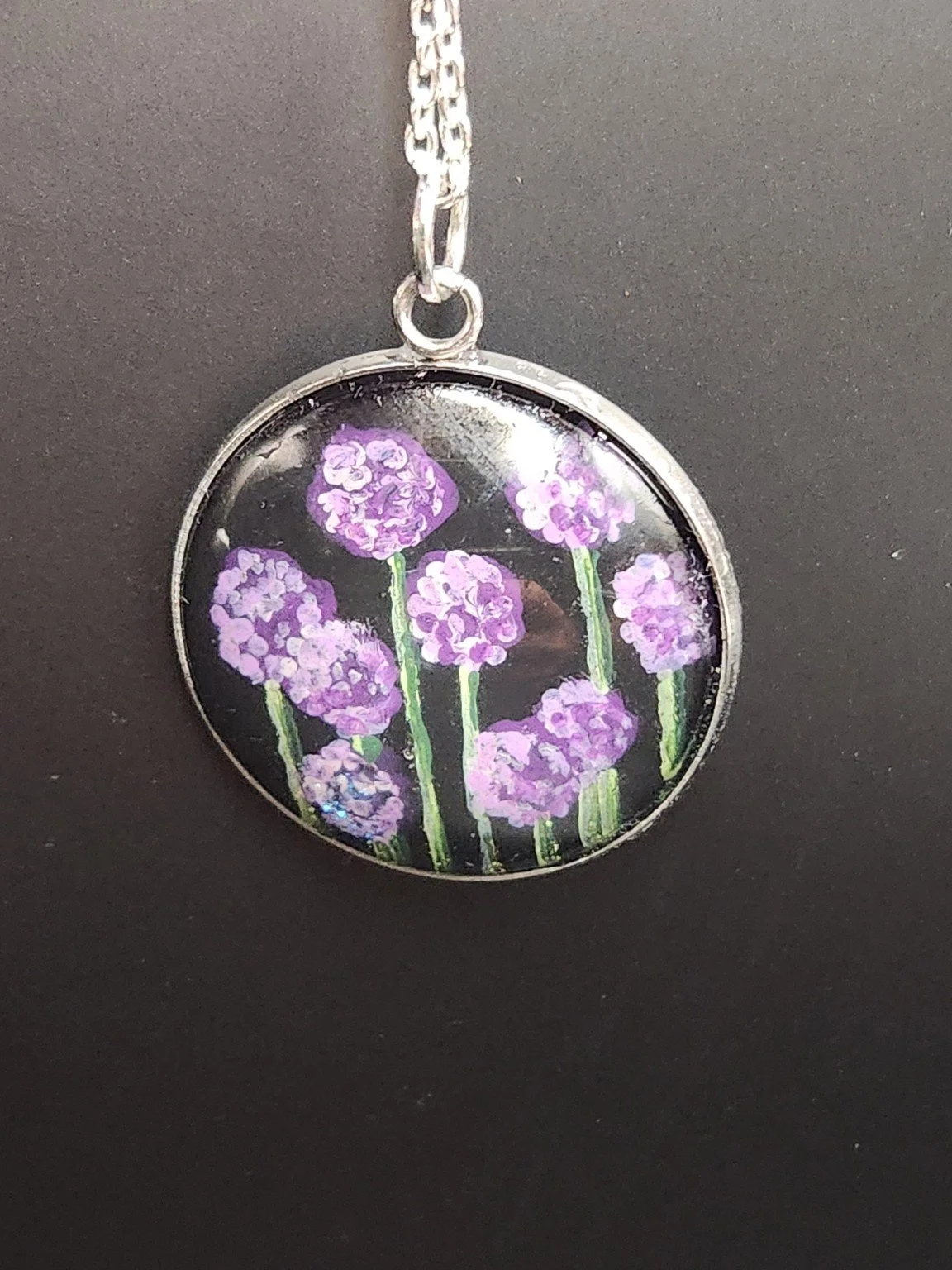 Allium pendant shown on a chain for styling; chain not included.
