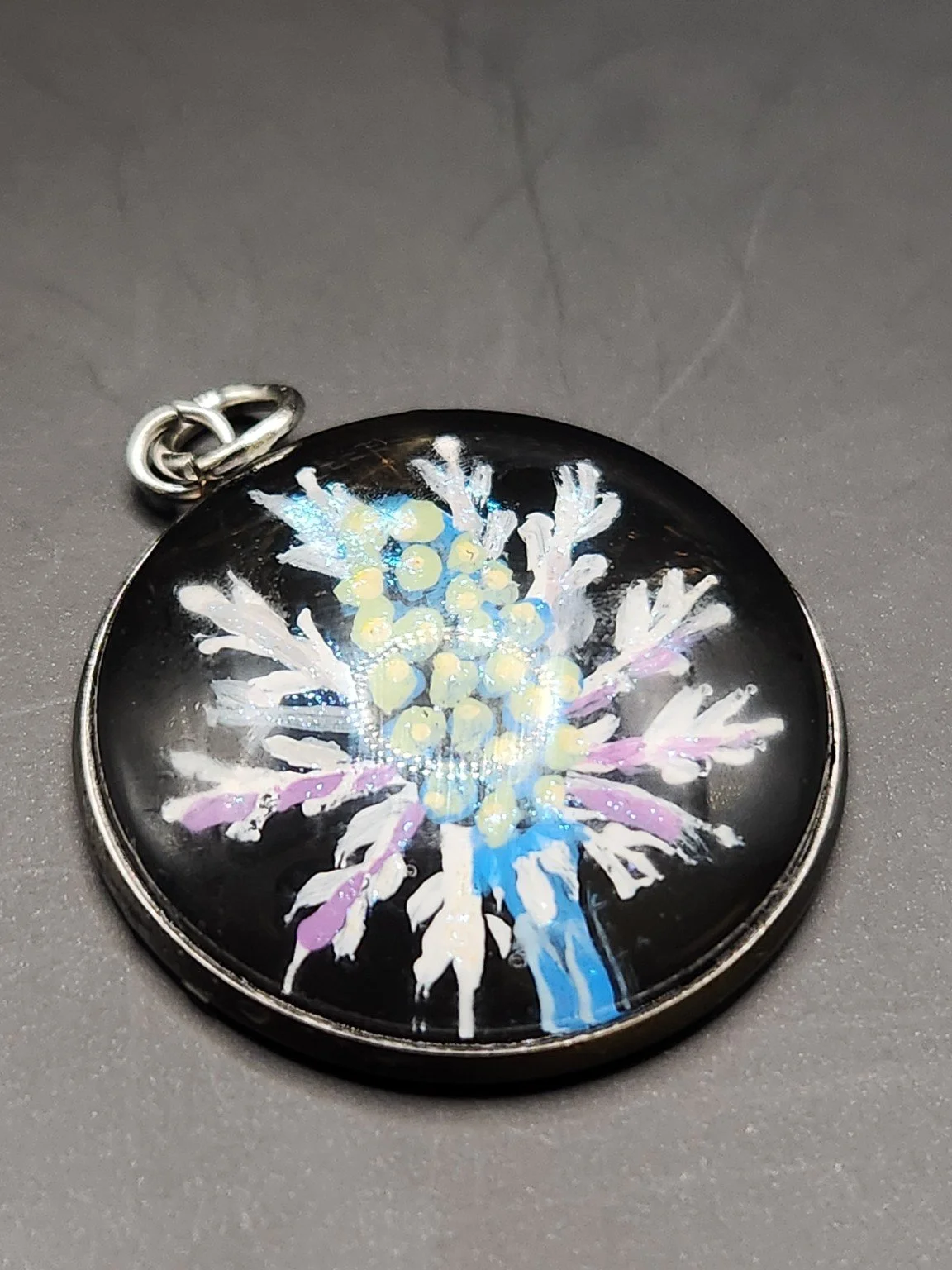 Blue and purple eryngium sea holly flower art pendant with shimmering glitter accents.