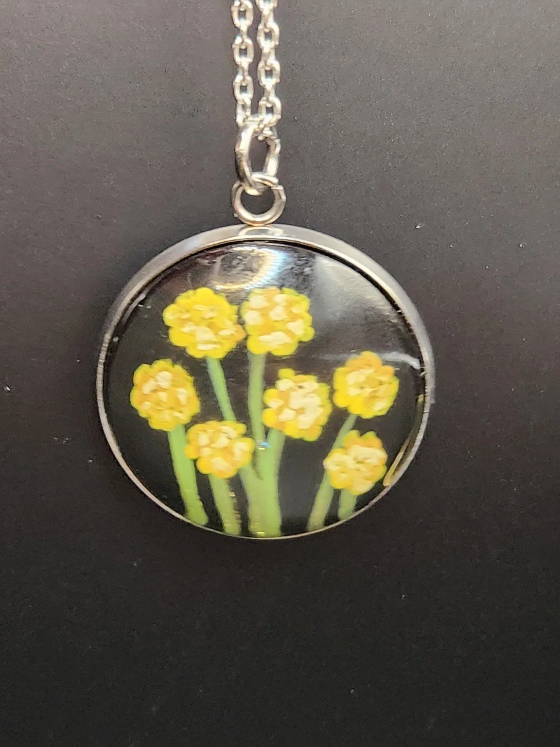 Yellow billy button flower art pendant hanging from a silver-tone chain. Chain not included.