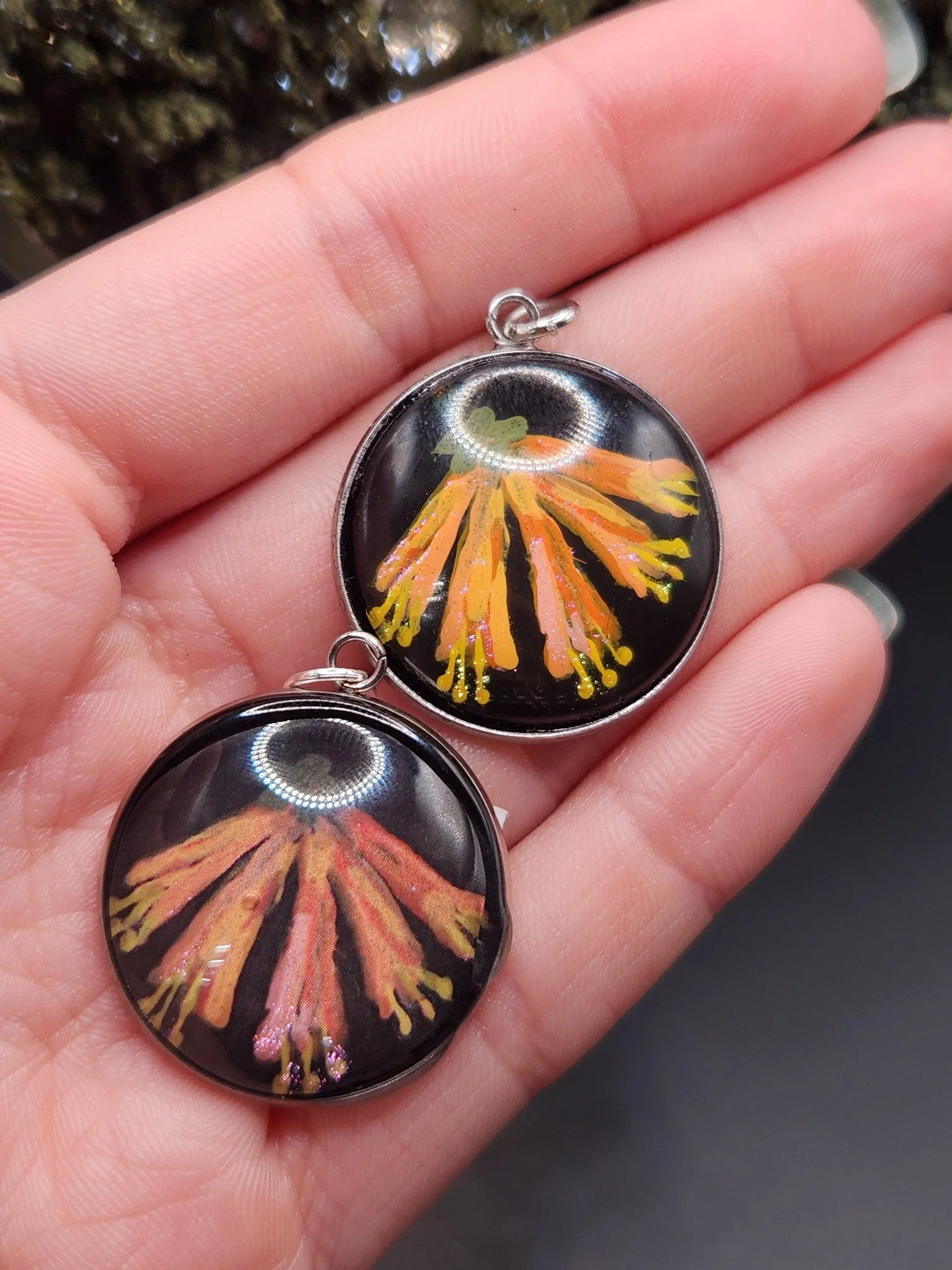Honeysuckle pendants shown in hand: hand-painted original on top and printed reproduction below.