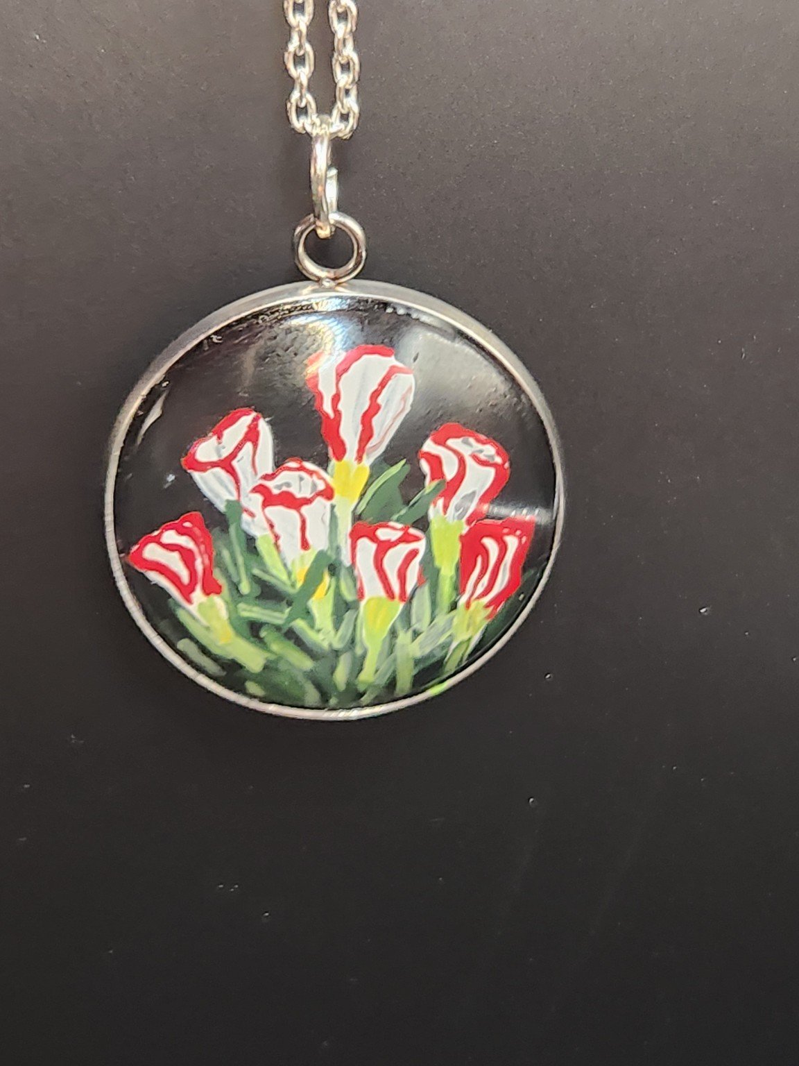 Candy cane sorrel flower art pendant hanging from a silver-tone chain. Chain not included.