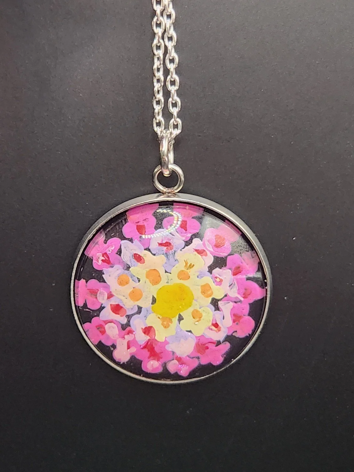 Pink and yellow lantana flower art pendant hanging from a silver-tone chain. Chain not included.