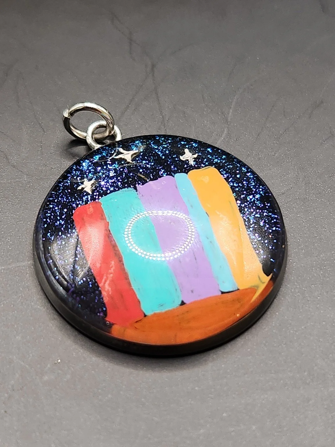 Hand-painted ACOTAR-inspired pendant with a colorful book lineup, glitter accents, and Velaris mountains and stars.