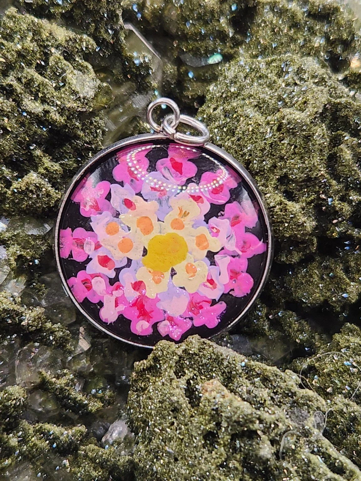 Lantana flower cluster art pendant displayed among green crystals. Crystal display and styling props not included.
